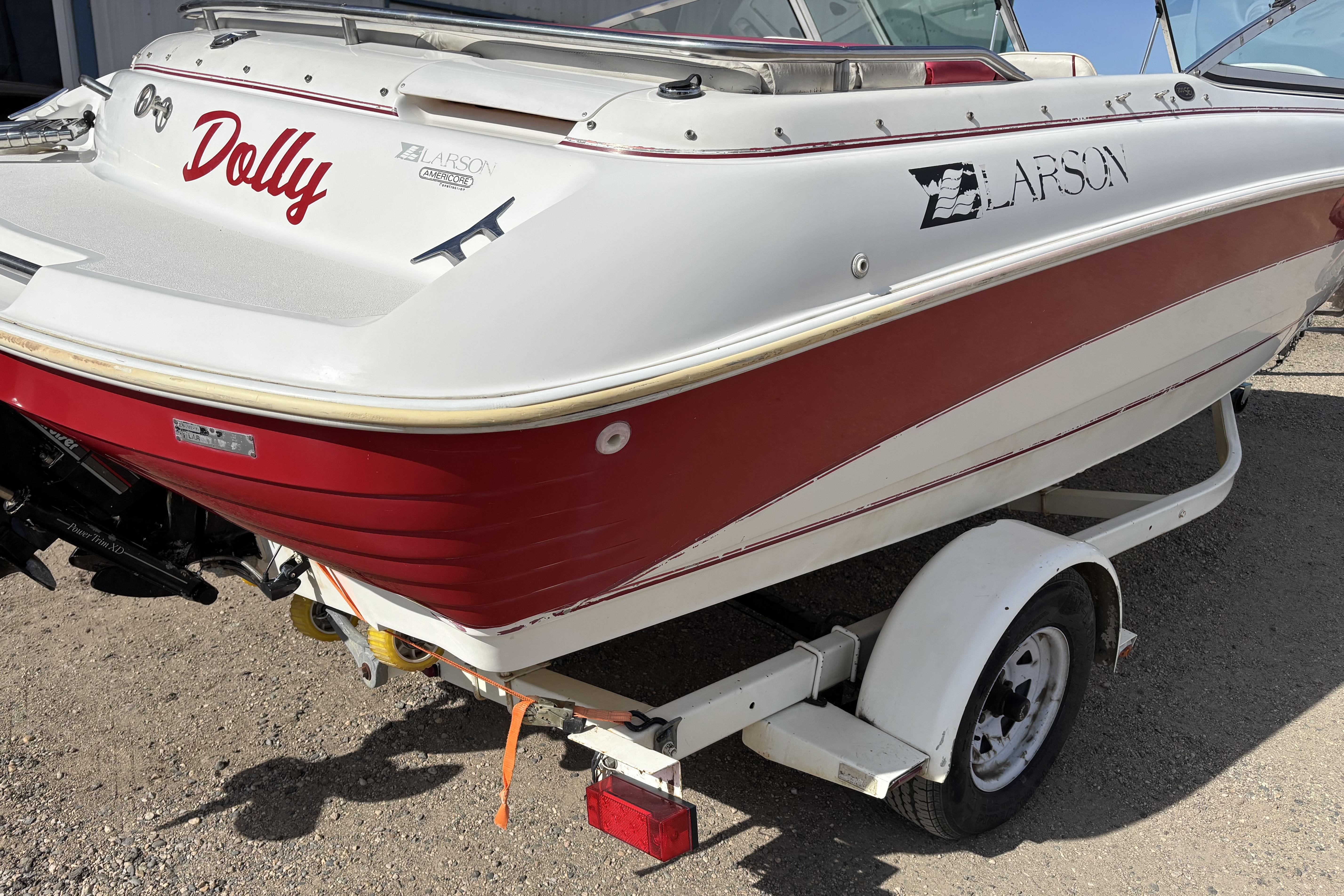 1993 Larson SEi 200 Cuddy I/O boat with red and white exterior on trailer.
