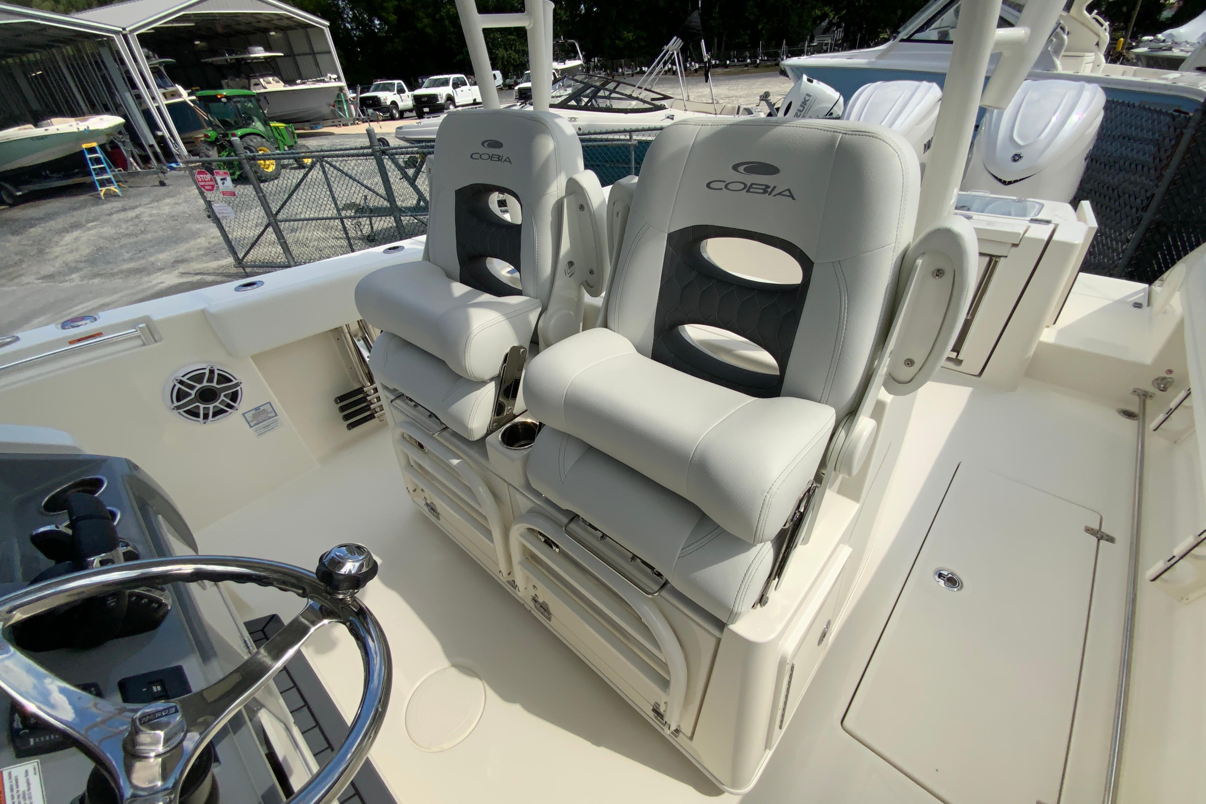 2027 Cobia 320 Center Console boat interior with dual cushioned seats.