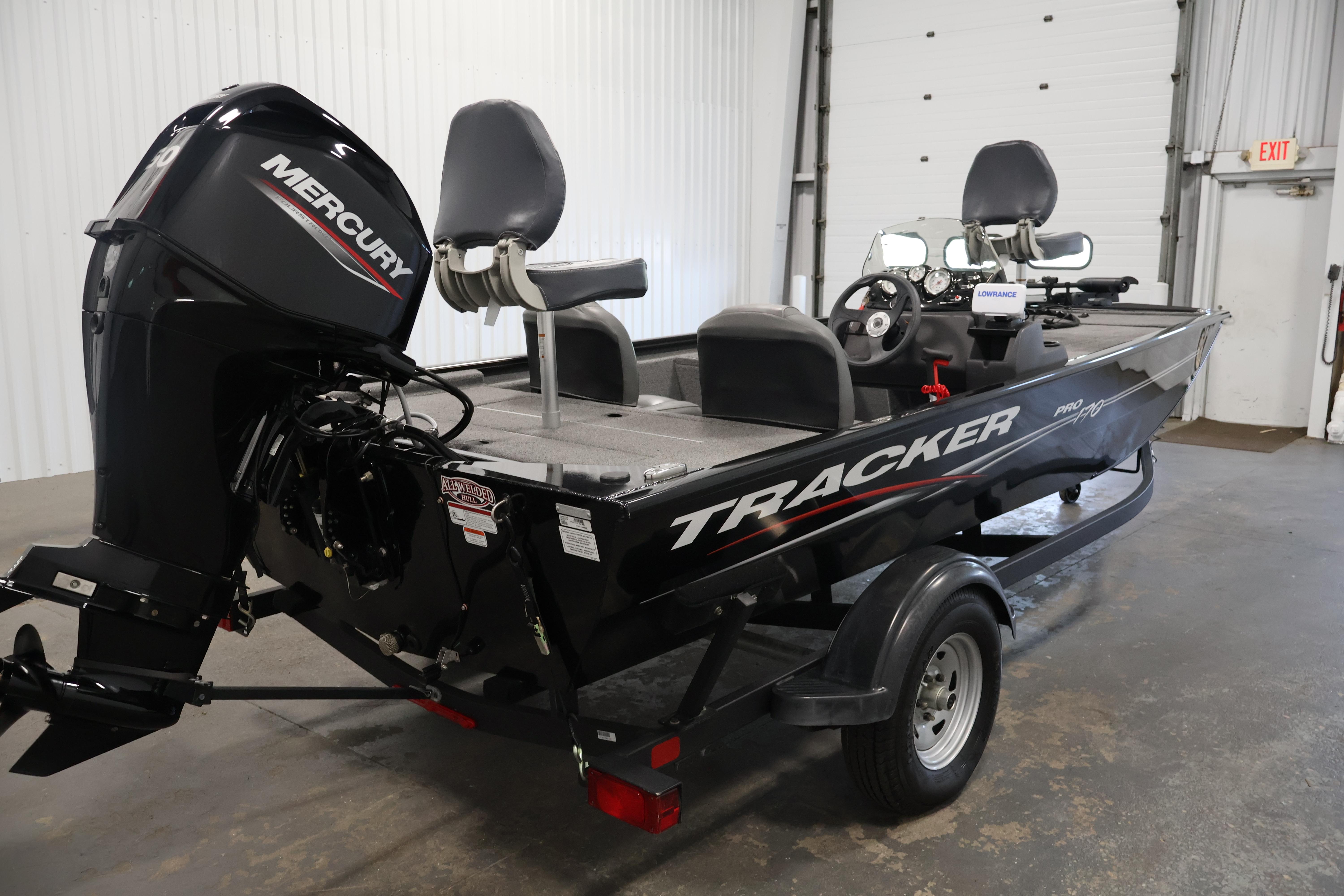 2024 Tracker Pro 170 boat with Mercury engine in a garage setting.