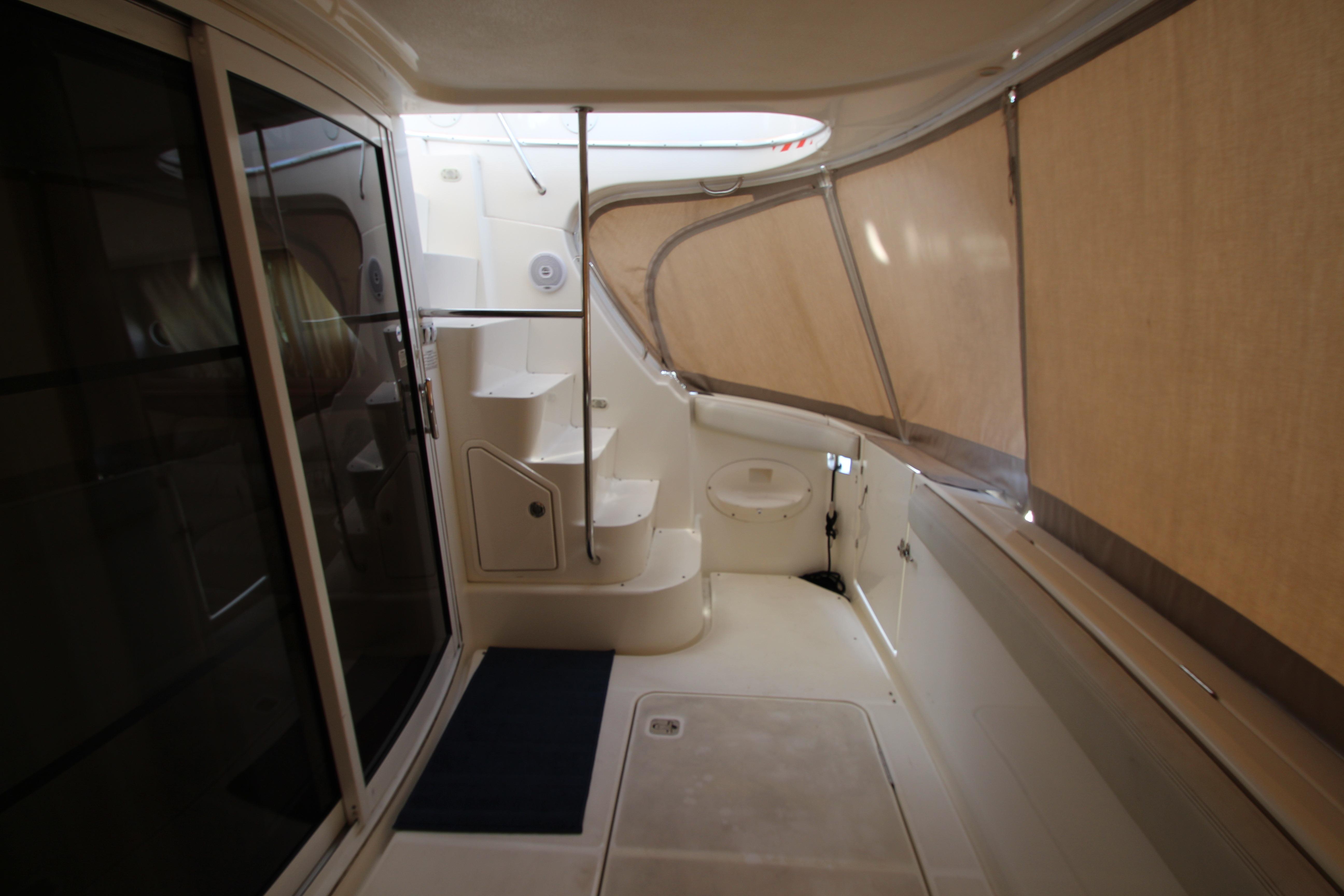 2006 Silverton 38 Sport Bridge interior with stairs and enclosed deck area.
