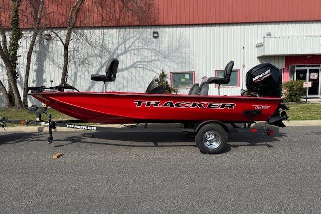 2026 Tracker Pro Team 175 boat in vibrant red, parked outdoors.