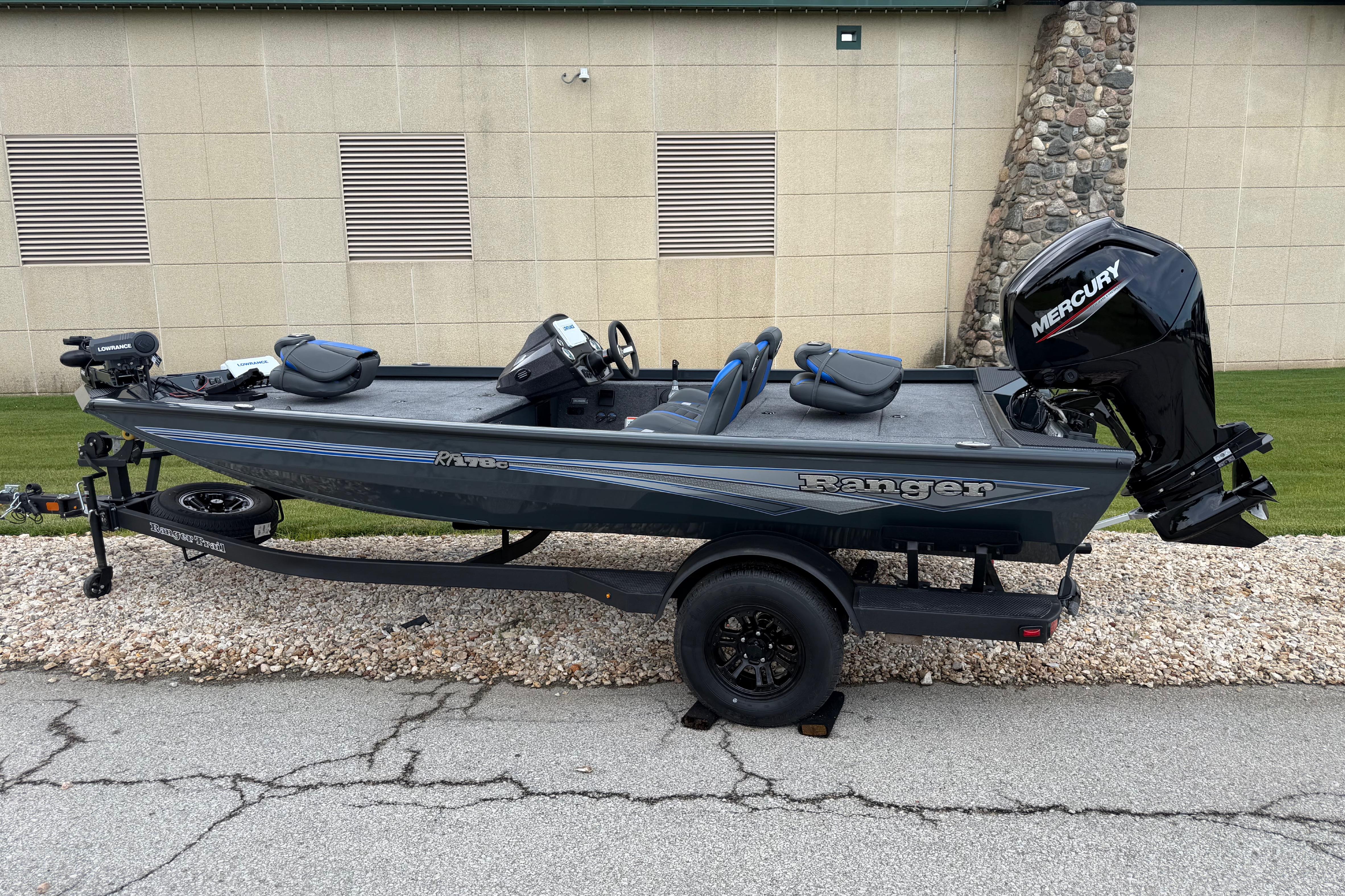 2026 Ranger RT178C fishing boat with Mercury engine on trailer, parked outdoors.