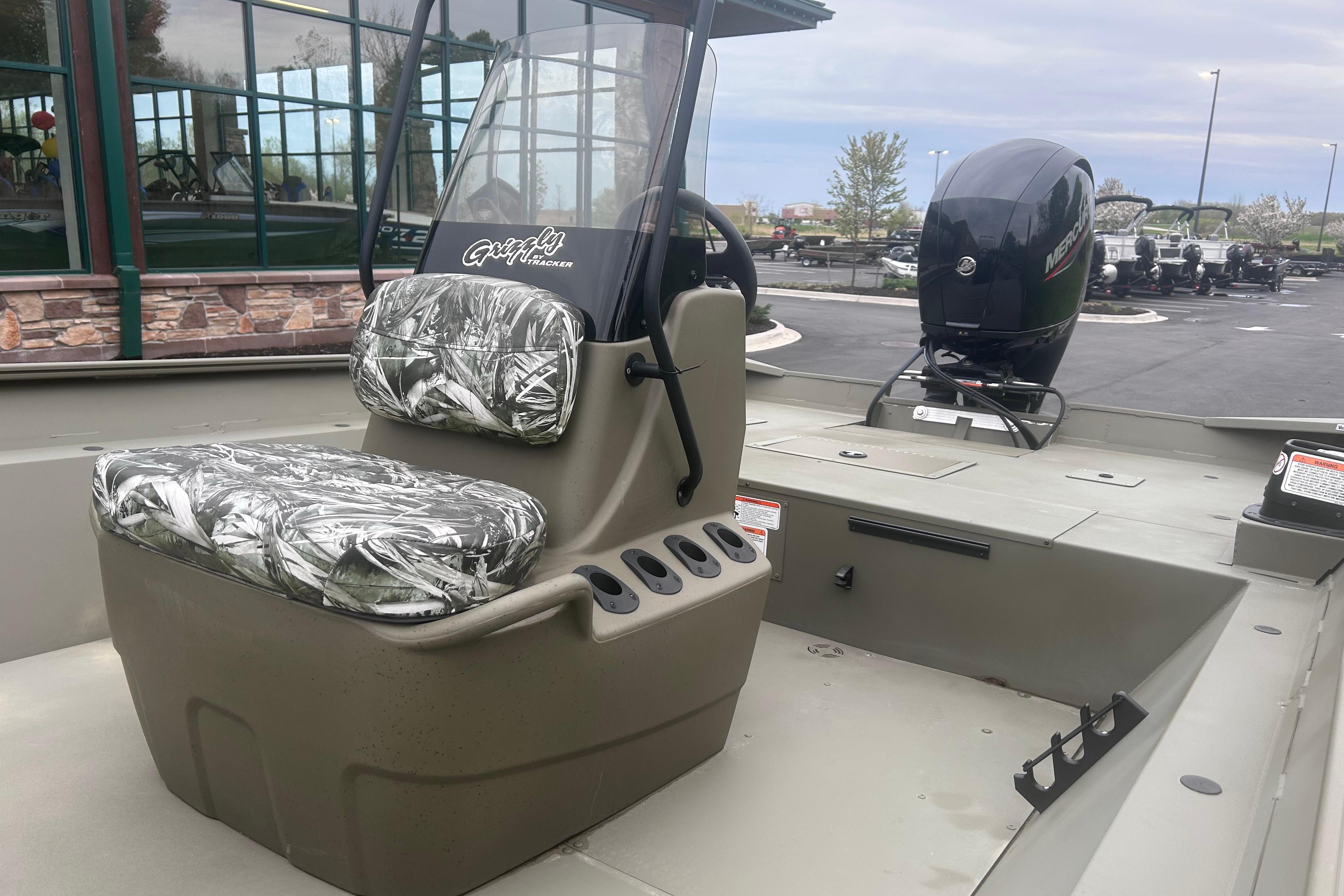 2024 Tracker Grizzly 2072 CC boat with camo seats and Mercury outboard motor.