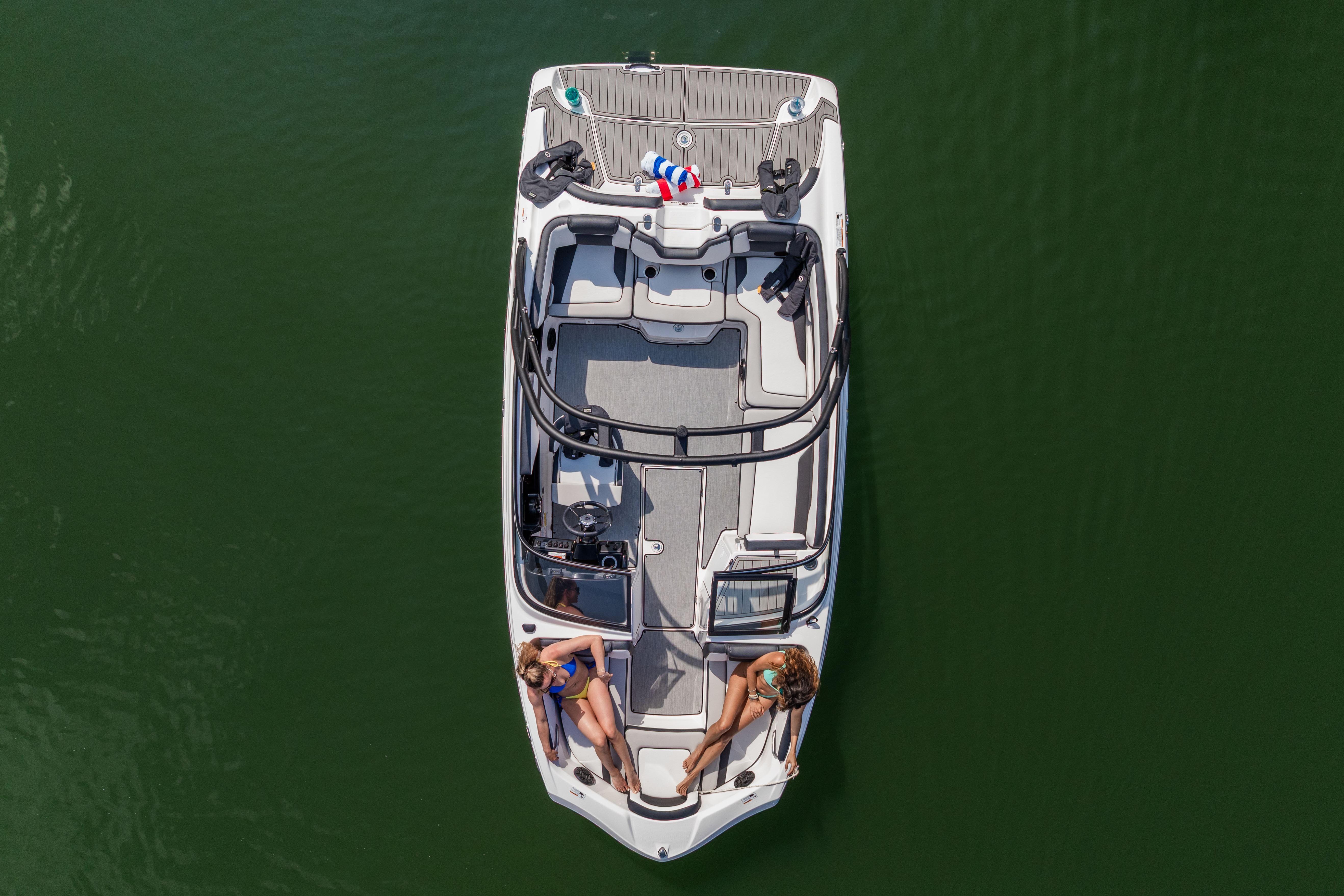 Manufacturer Provided Image: 2026 Yamaha Boats AR195 on water, top view with two people relaxing onboard.