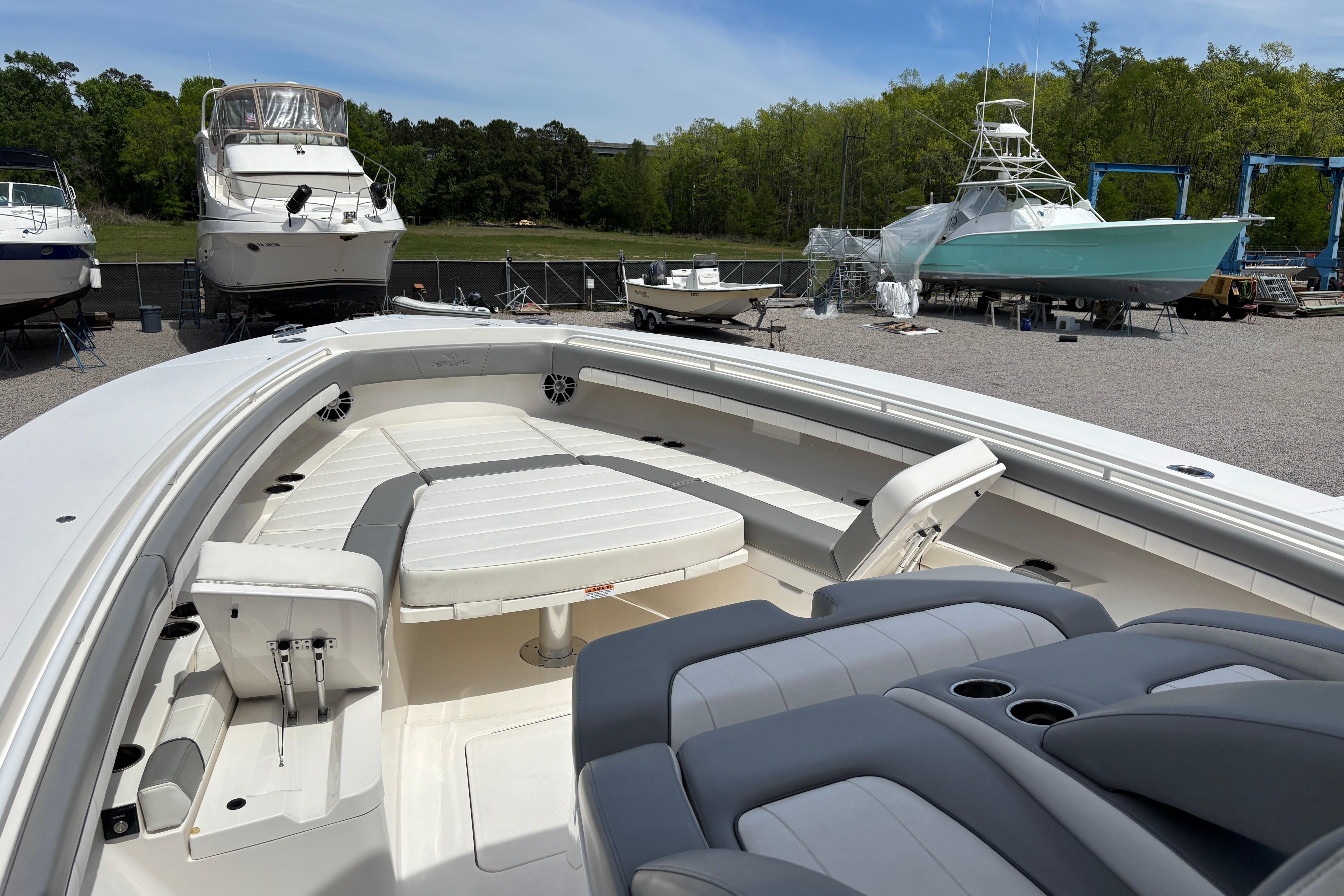 2023 Regulator 41 boat with spacious seating, docked among other vessels.