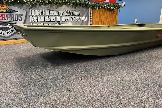 2026 Tracker Grizzly 12 Jon boat displayed indoors on carpeted floor.