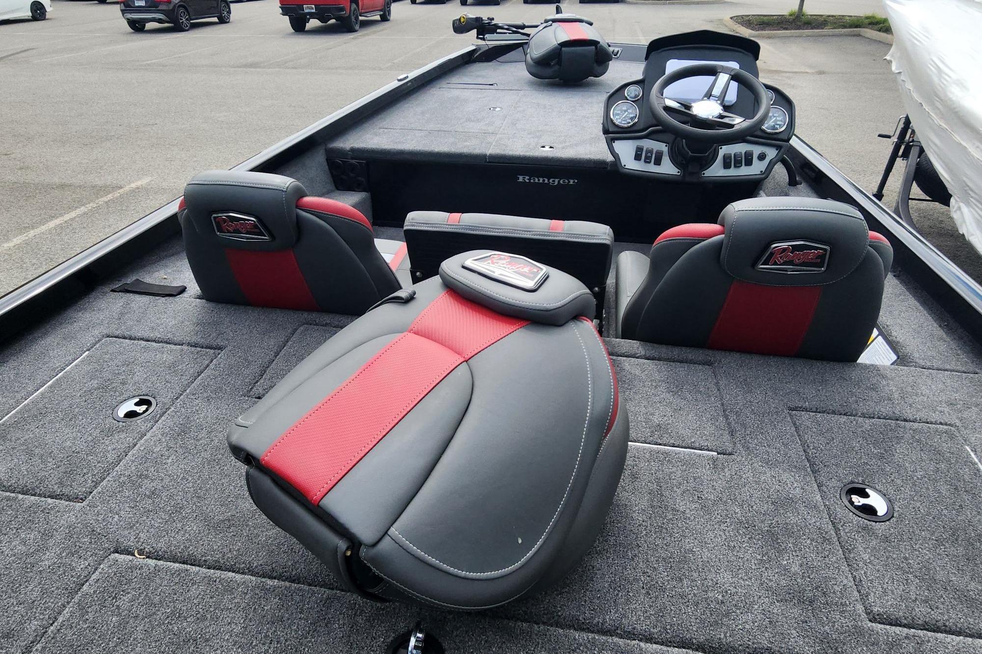 2026 Ranger RT188 boat interior with red and gray seating, steering console, and carpeted deck.