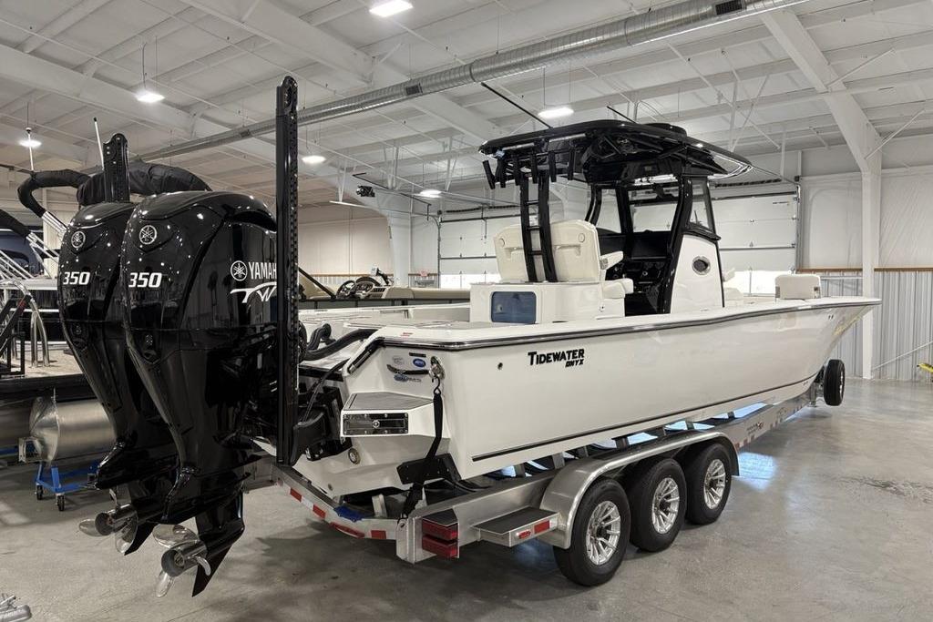 2026 Tidewater 3100 Carolina Bay boat with dual Yamaha 350 engines in a showroom.