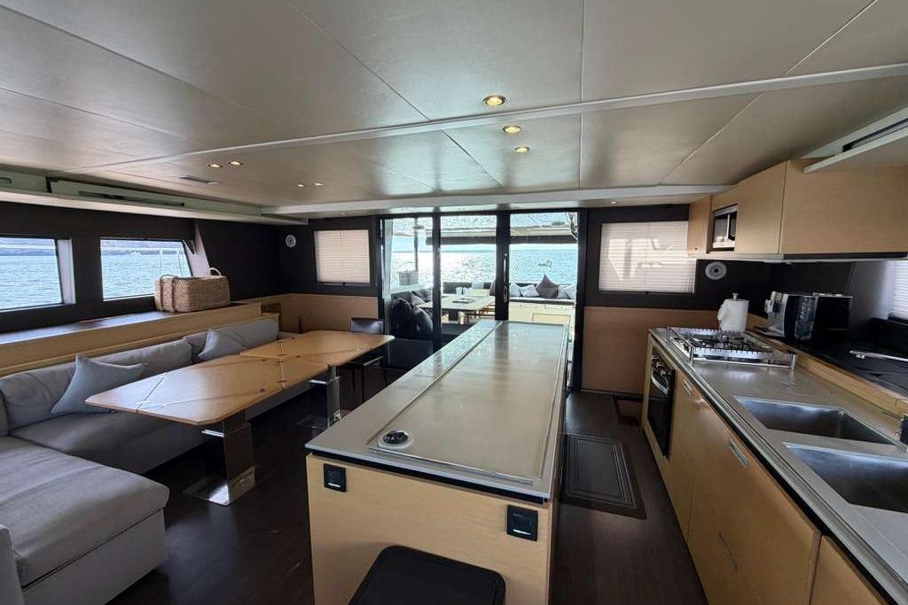 Luxurious interior of 2019 Lagoon 630 MY yacht with modern kitchen and seating area.
