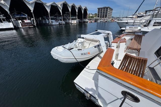 1993 Ocean Alexander 440 Sundeck CPMY docked with inflatable boat, marina backdrop.