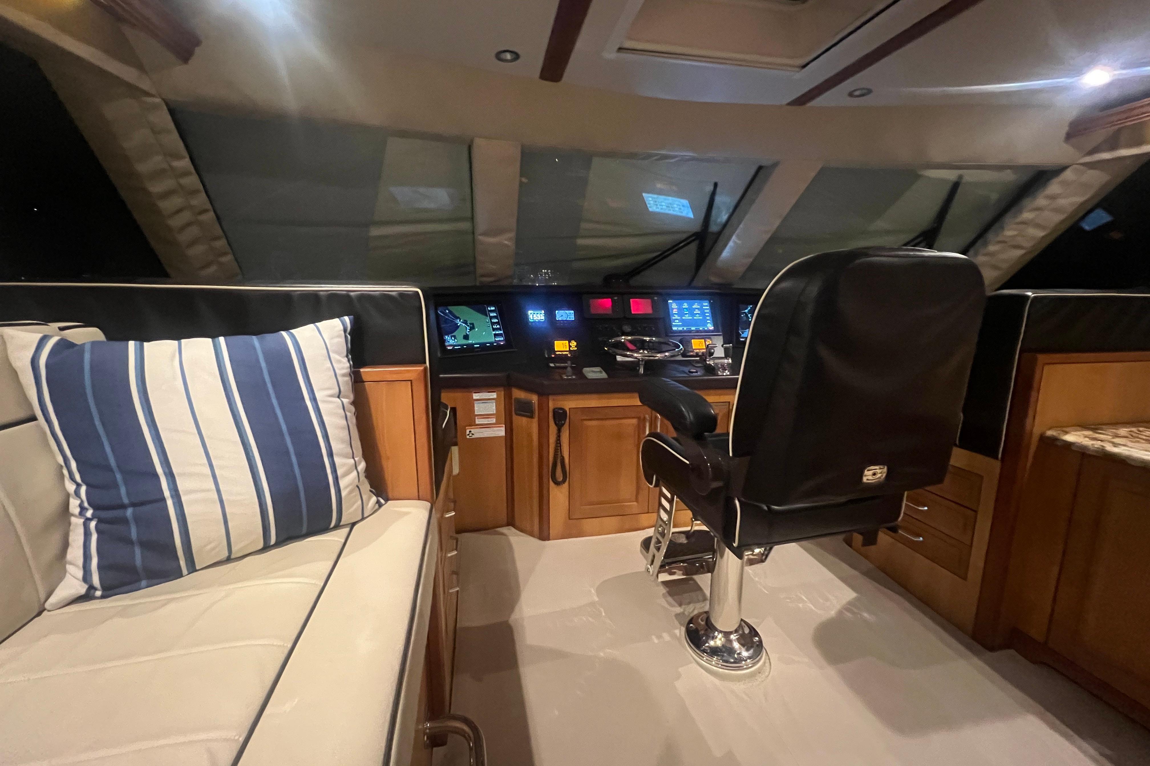 Interior of 2013 Hatteras GT63 yacht cockpit with navigation controls and seating.
