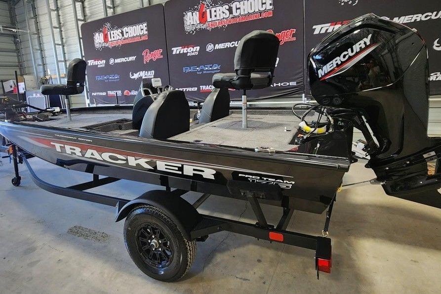 2026 Tracker Pro Team 175 boat with Mercury engine in showroom setting.