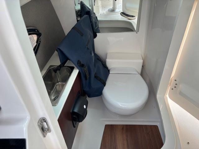 Compact bathroom in 2026 Chaparral SSX 6 boat with sink and toilet.