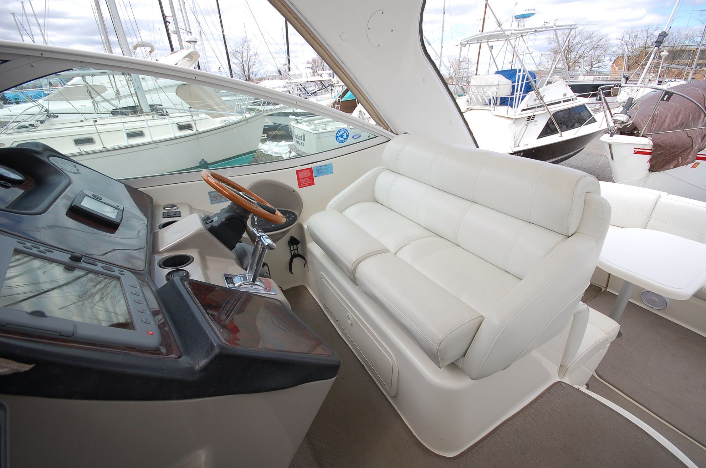Interior of a 2004 Cruisers Yachts 3970 with white seating area.