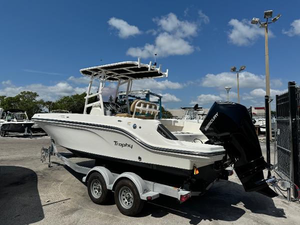 2021 Bayliner Trophy T22CC boat on a trailer in a marina.
