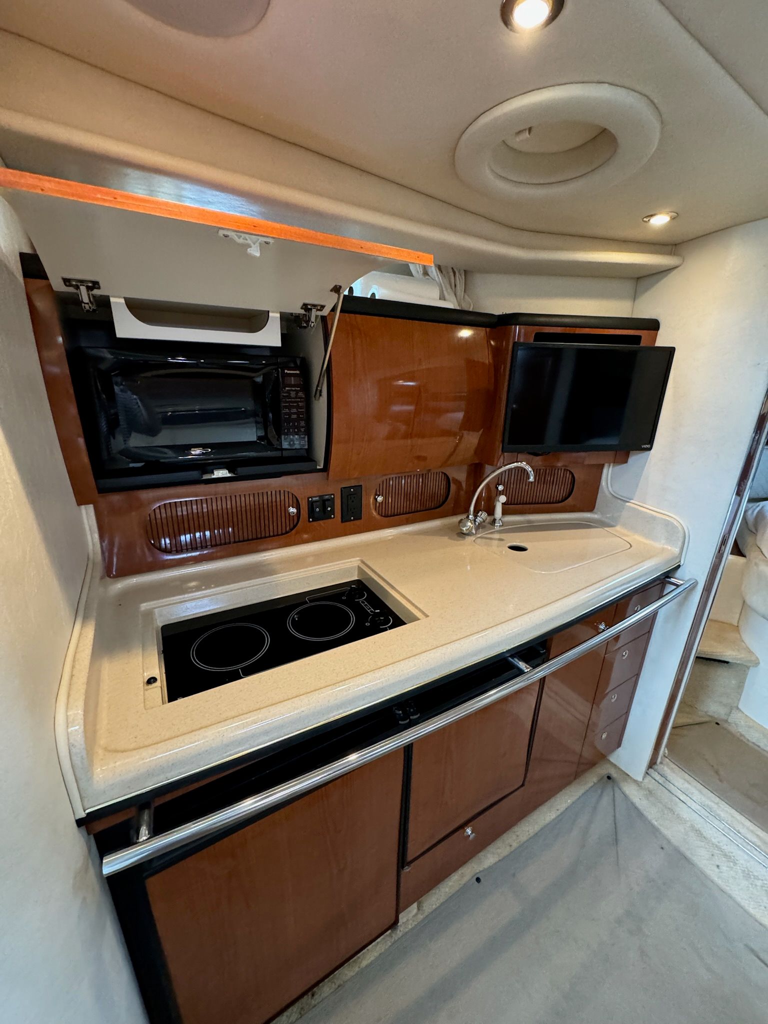 Interior of 2002 Sea Ray 360 Sundancer with kitchen and stove.
