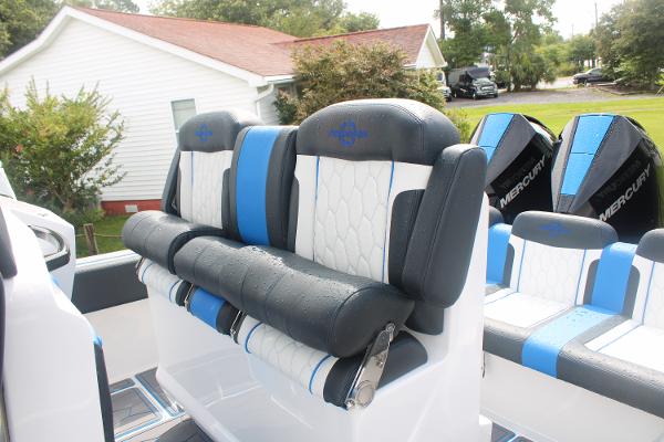 2024 Fountain 34 SC boat interior with blue and white seating and Mercury engines.