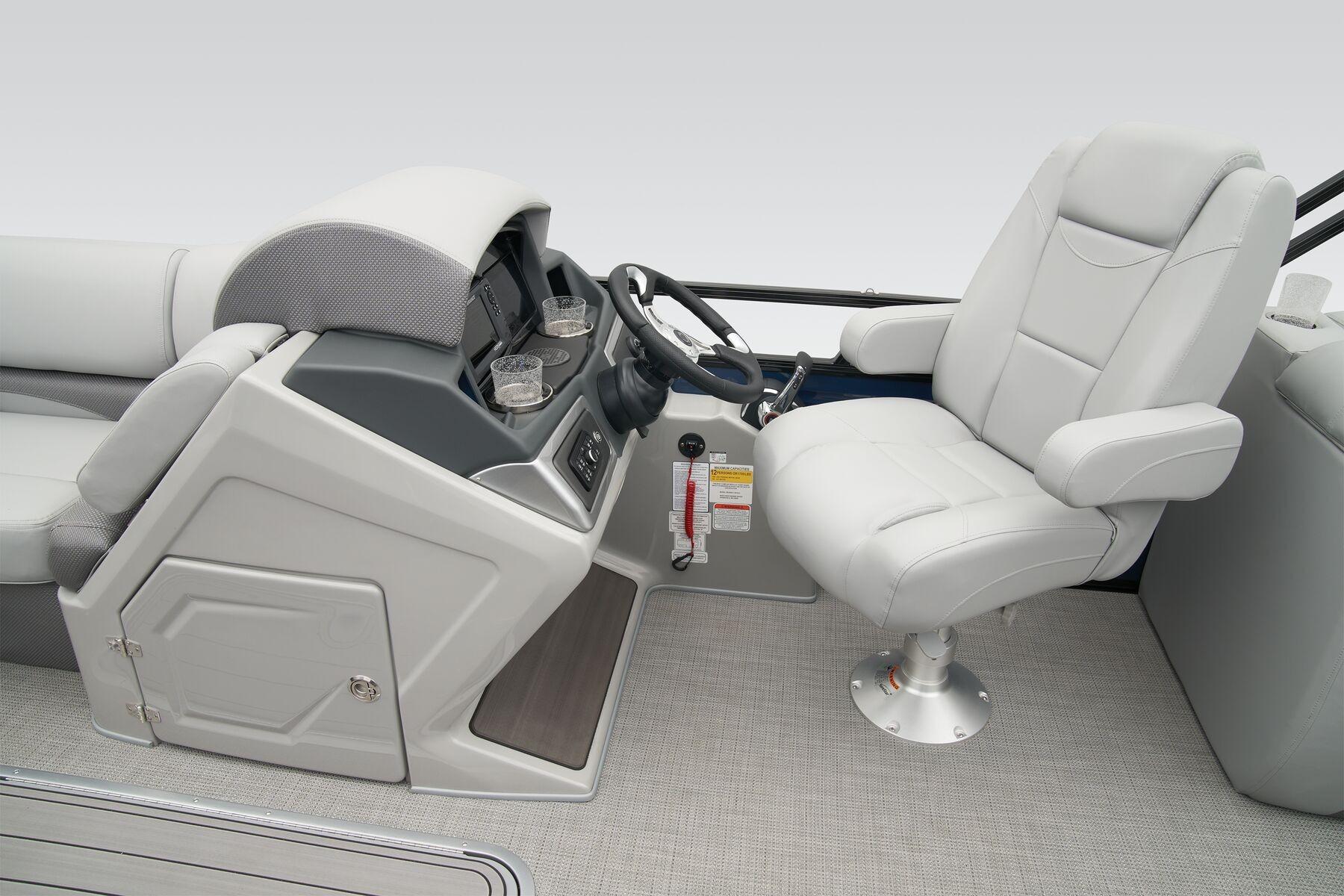 2026 Regency 230 DL boat interior with captain's chair and control console.