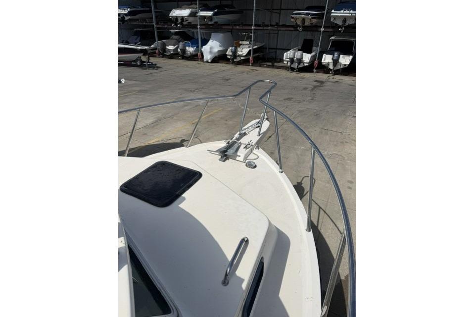 2006 Parker 2520 SL Sport Cabin boat bow with railing in storage facility.