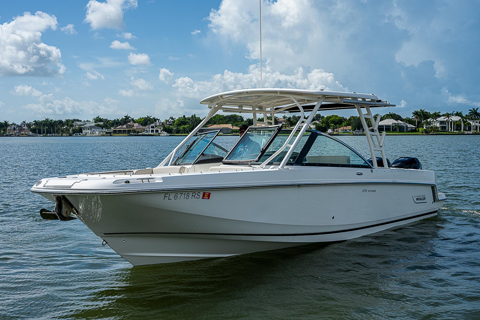 2018 Boston Whaler 270 Vantage boat on calm water under a blue sky.