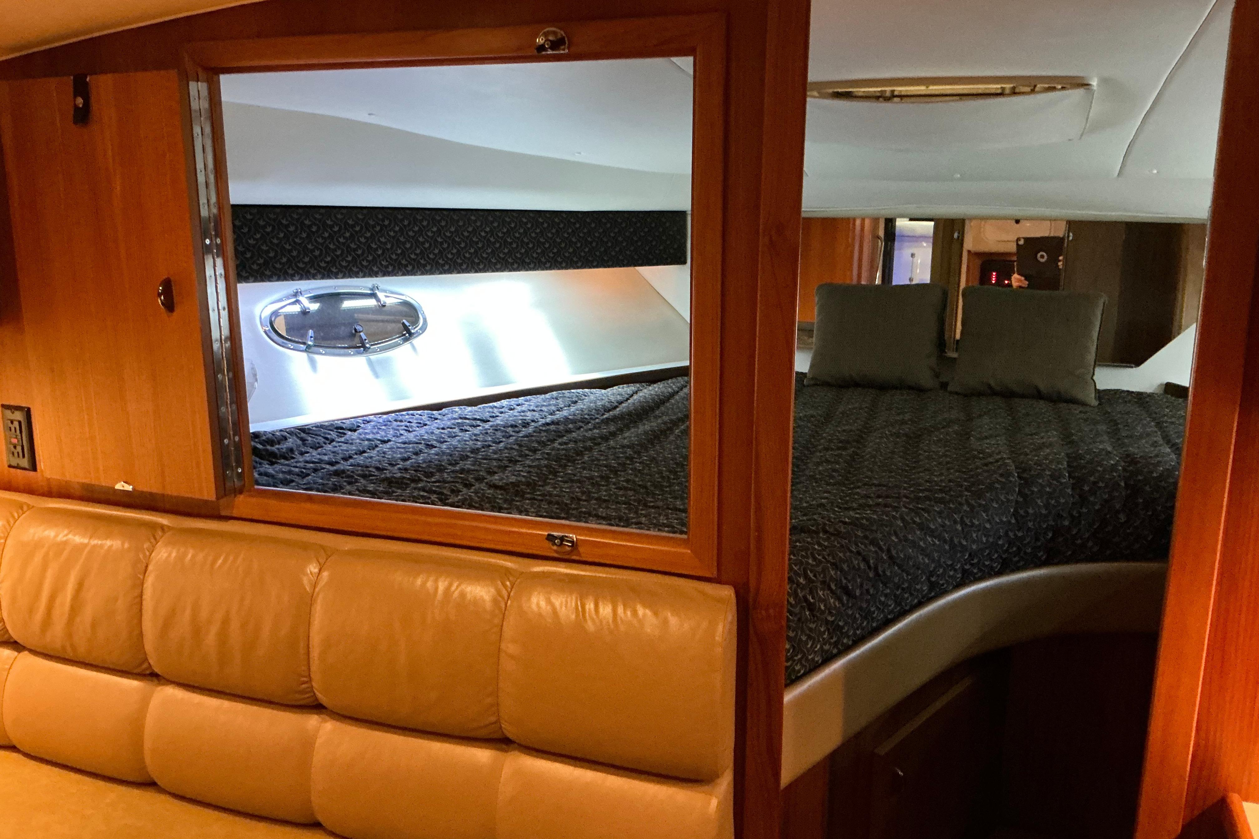 Interior cabin of 2000 Tiara Yachts 3500 Express with bed and seating area.