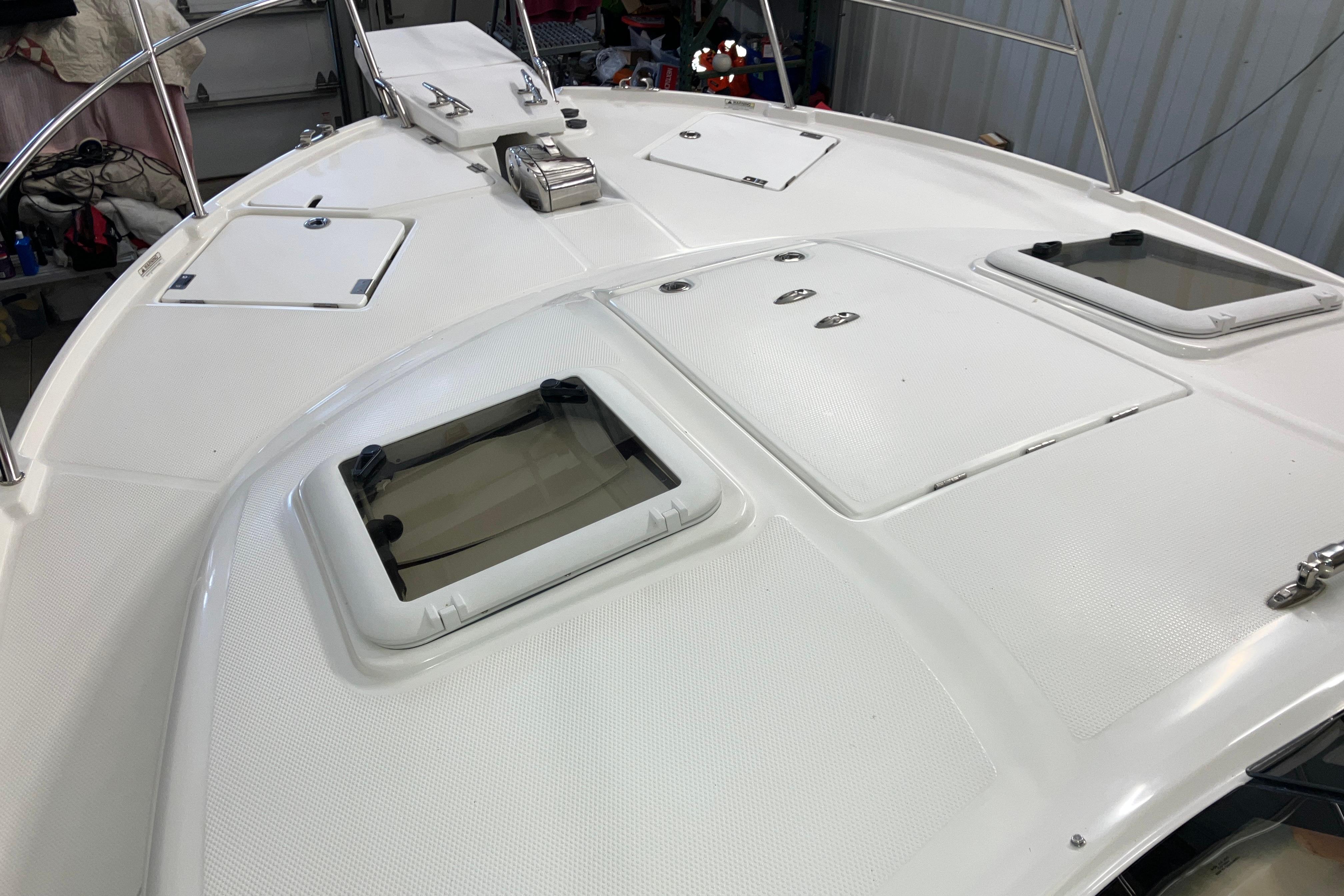 2017 Cutwater C-30 Sedan boat deck with hatches and railing in a storage area.