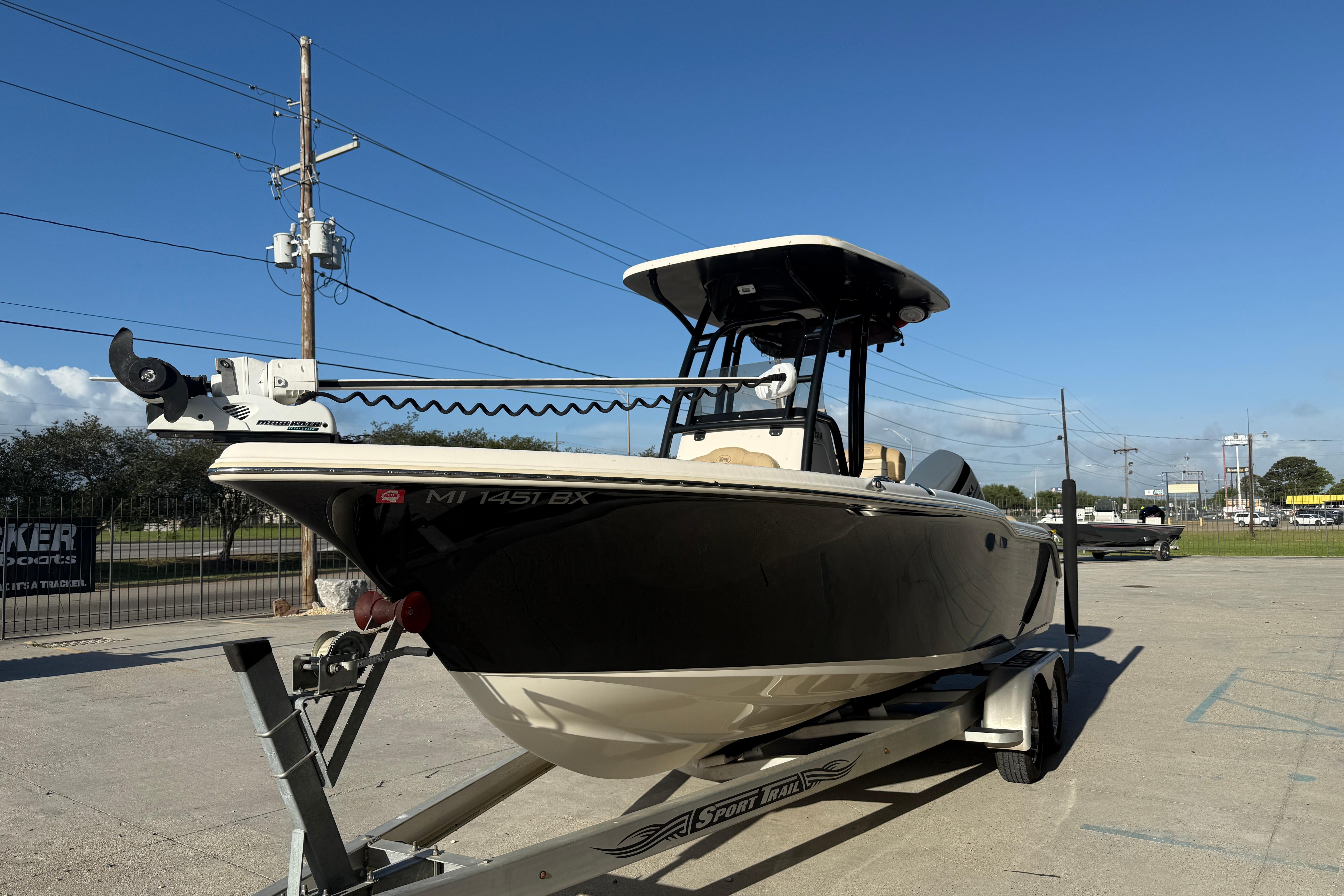 2016 Key West 239 FS boat on trailer under clear blue sky.