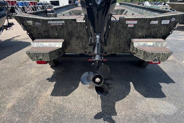 2026 Tracker Grizzly 2072 CC boat rear view with motor and camouflage design.