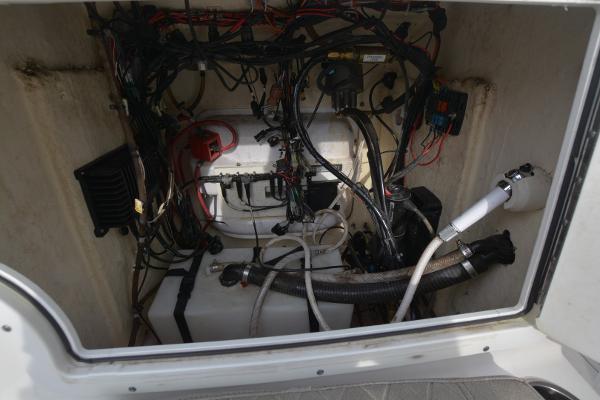 2021 Sea Pro 228 Bay boat wiring and equipment compartment, showcasing cables and components.