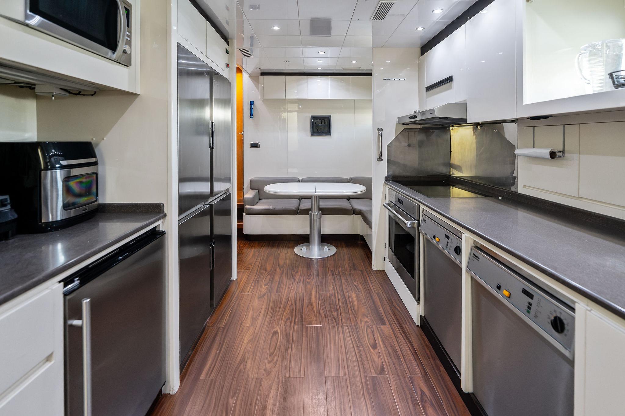 Luxurious 2005 Mangusta 130 yacht kitchen with modern appliances and sleek design.