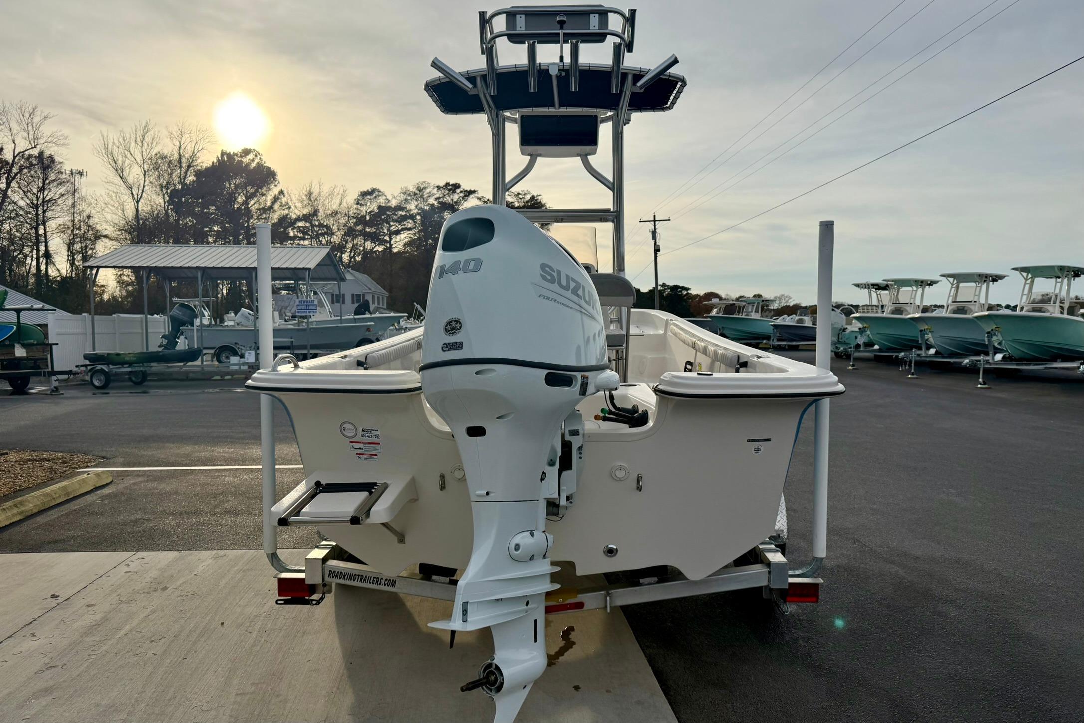 2025 Carolina Skiff 21 LS boat with Suzuki 140 outboard motor, parked outdoors.