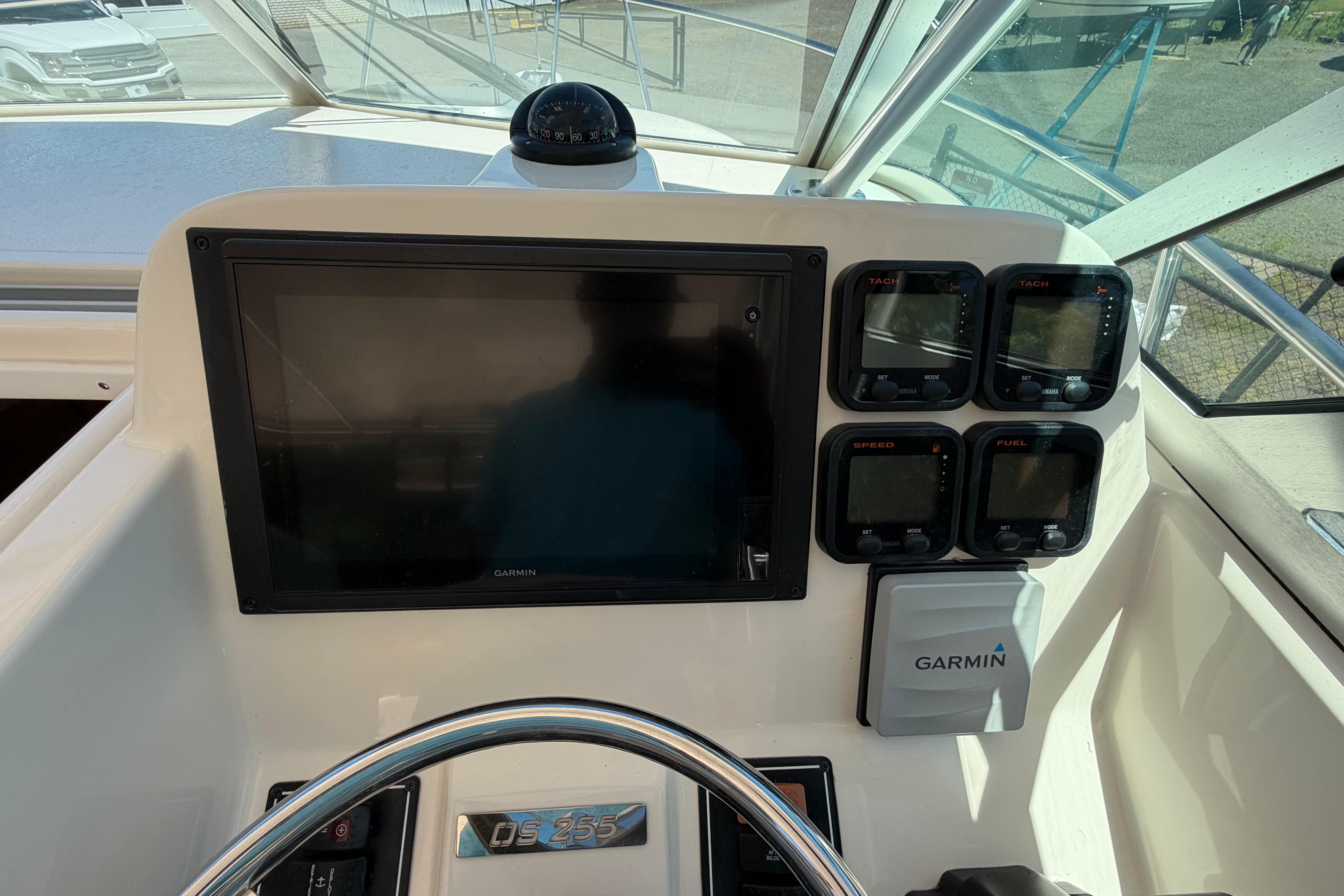 Dashboard of 2010 Pursuit OS 255 Offshore boat with Garmin navigation system.