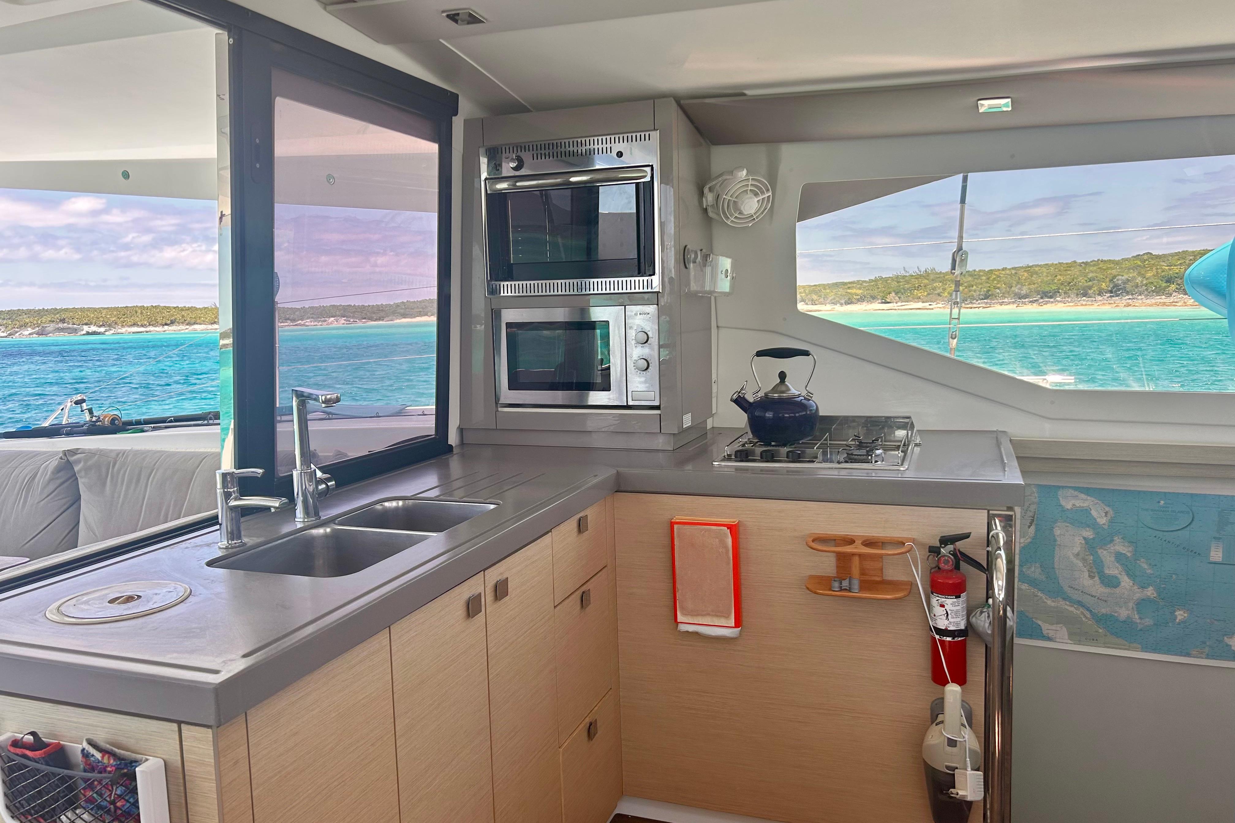 Modern kitchen interior of 2018 Fountaine Pajot Lucia 40 catamaran with ocean view.