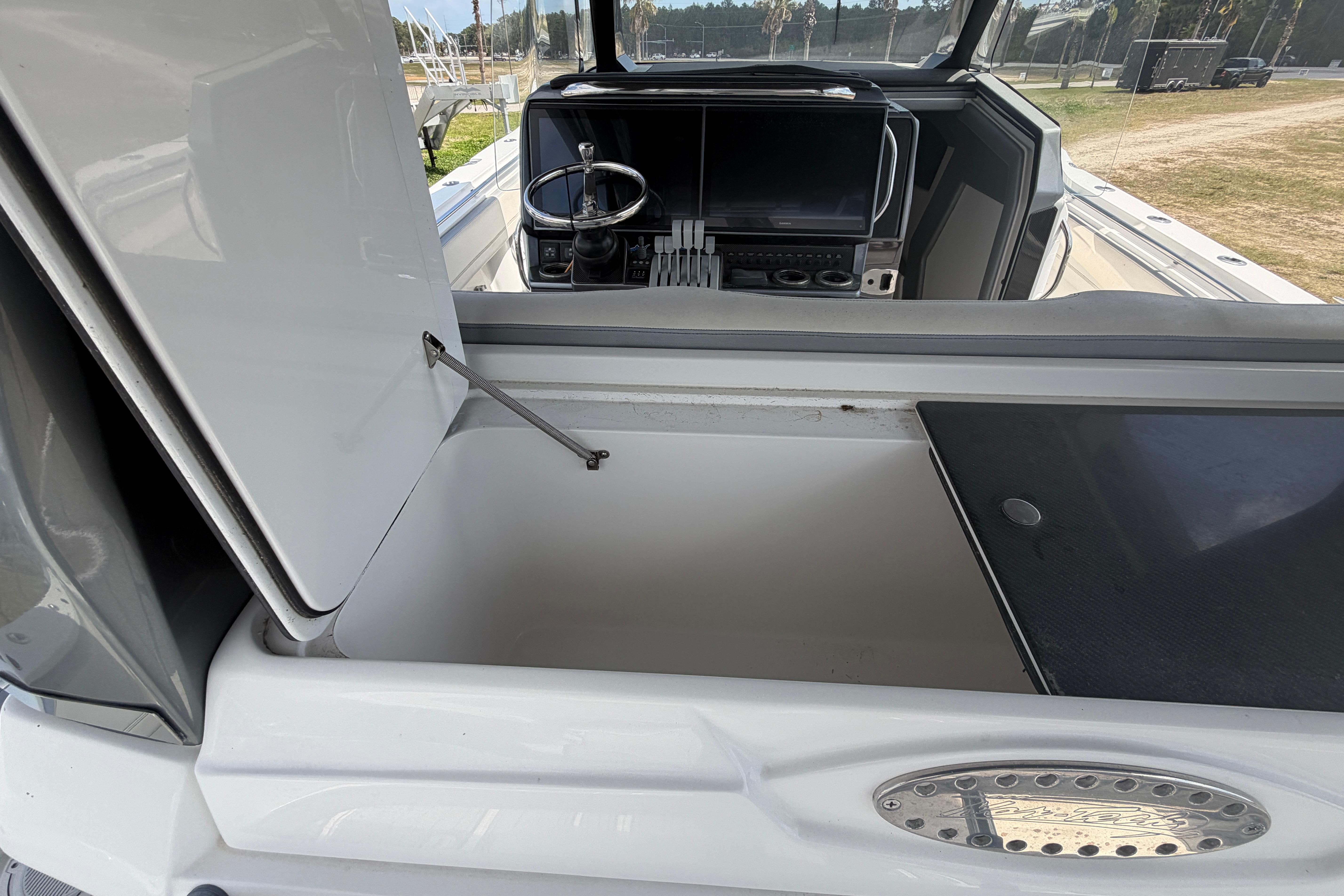 2018 Nor-Tech 452 Super Fish boat interior with open storage compartment and cockpit view.