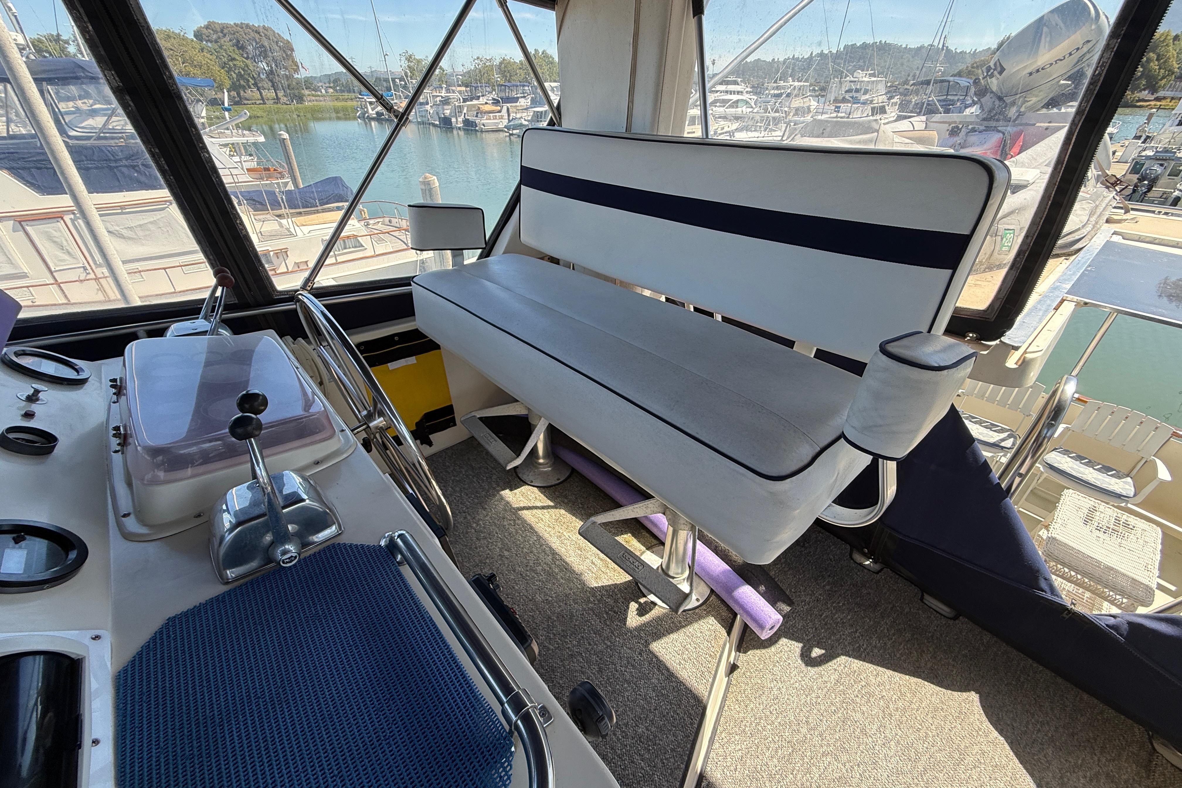 Interior of a 1987 PT Sundeck boat with helm and seating area.