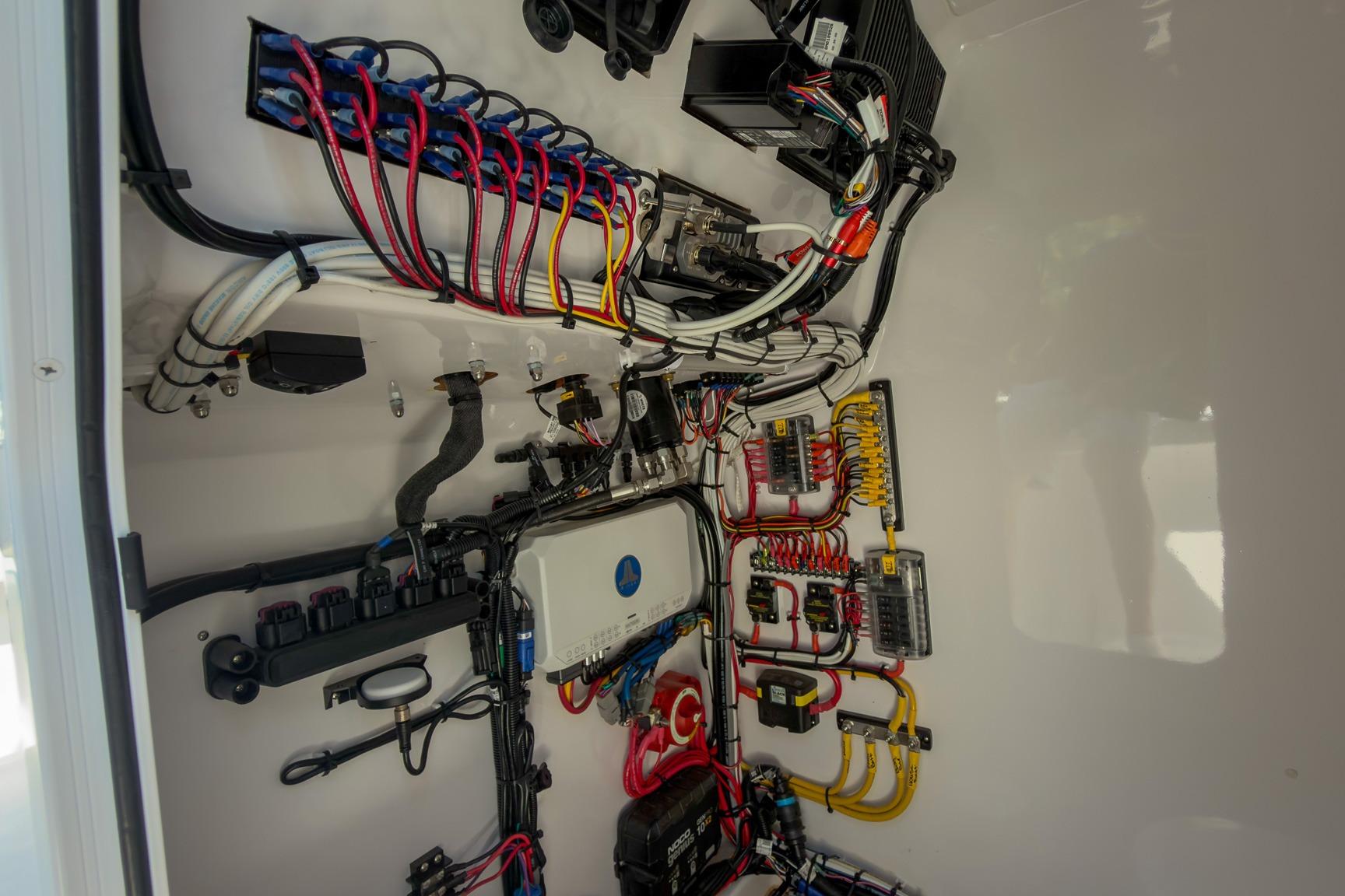 Electrical wiring system inside Weaver 25 model, 2025, showcasing organized cables and components.