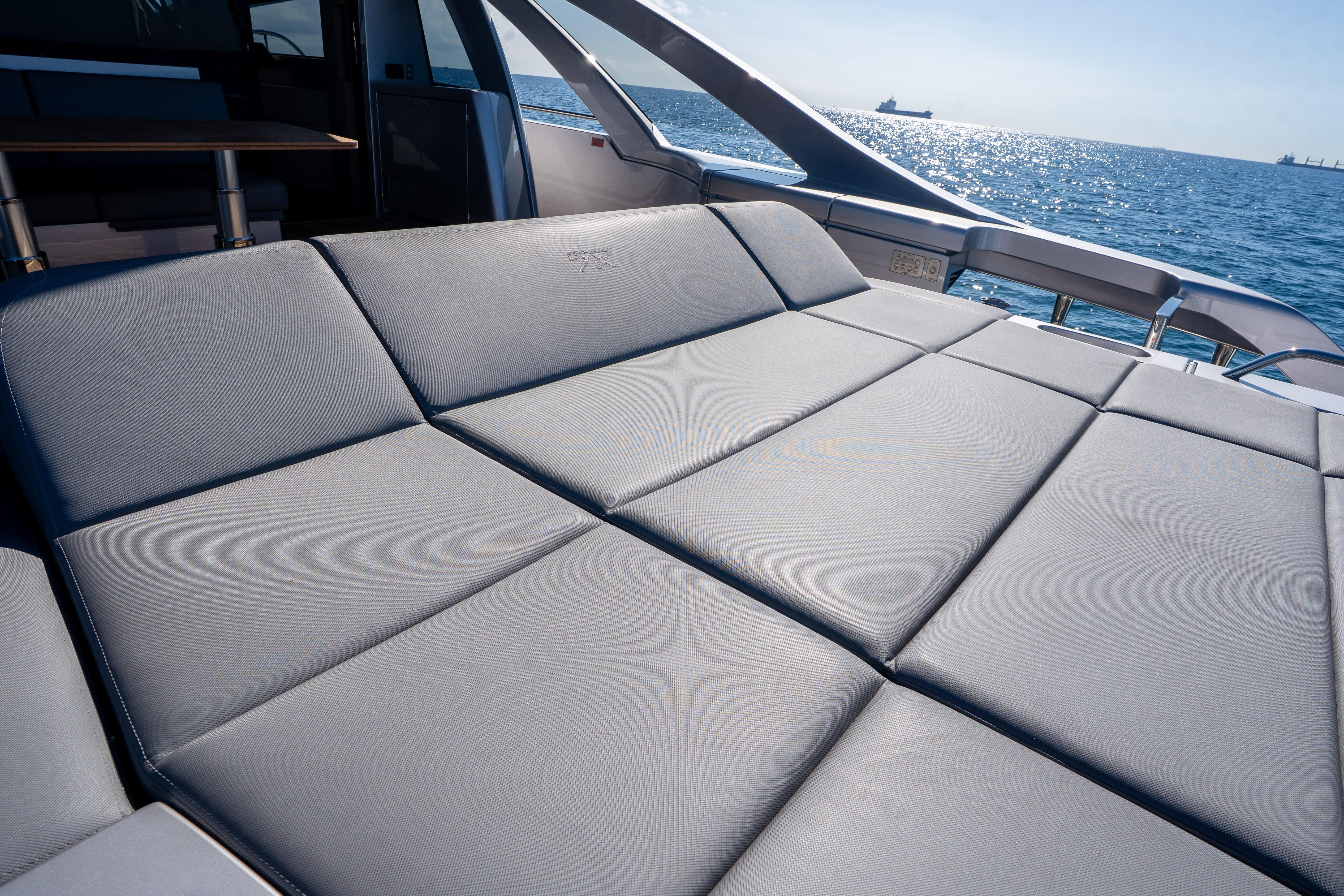 Luxurious sunbed on 2024 Pershing 7X yacht, overlooking serene ocean waters.