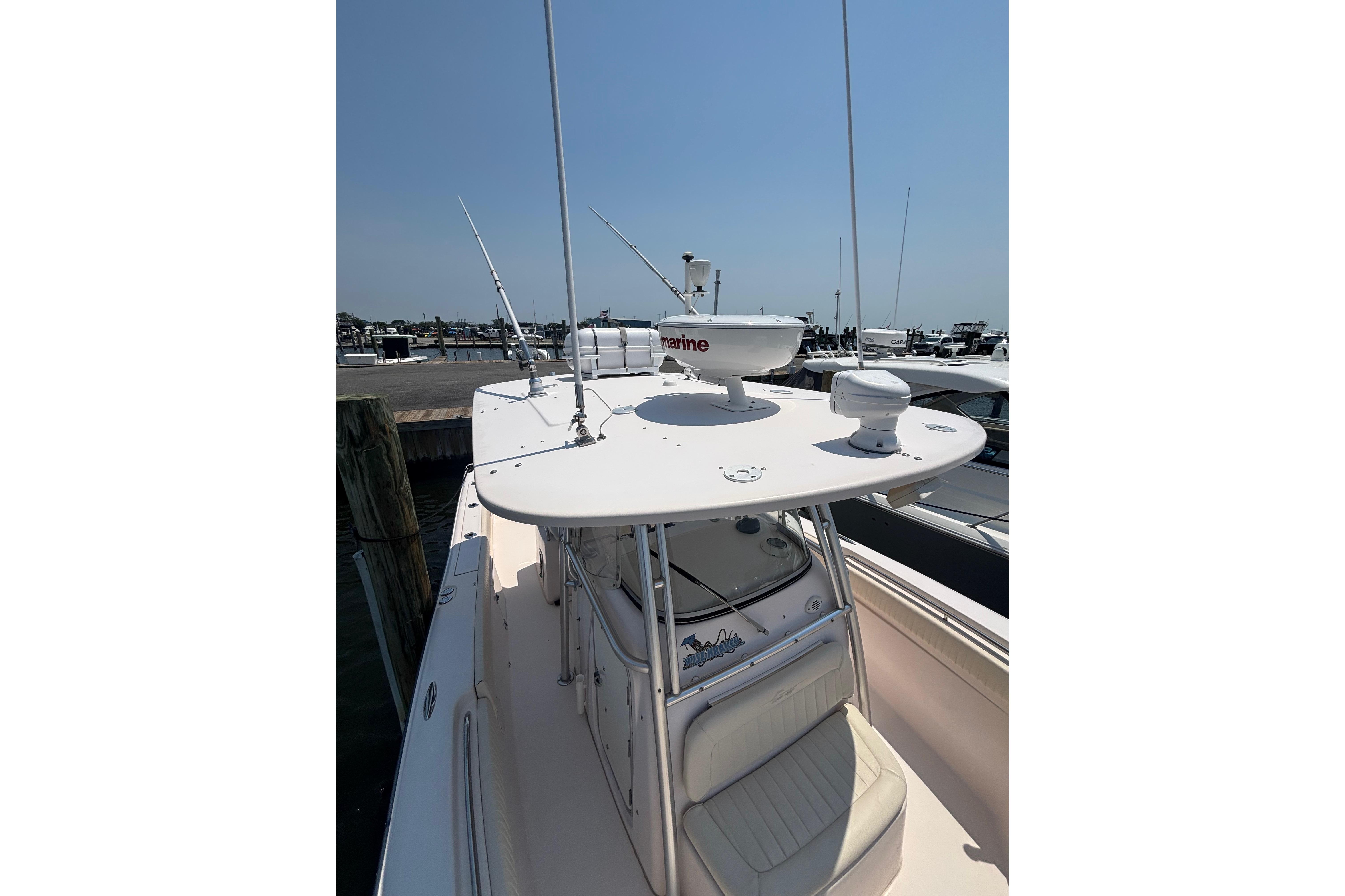 2007 Grady-White Bimini 306 boat docked, featuring radar equipment and spacious seating.