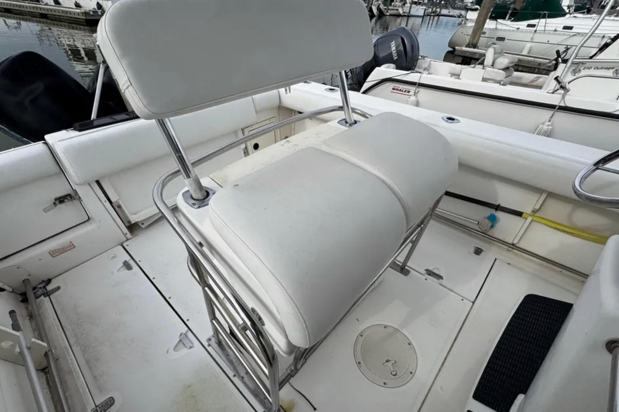 2001 Boston Whaler 26 Outrage boat interior with white seating and stainless steel frame.