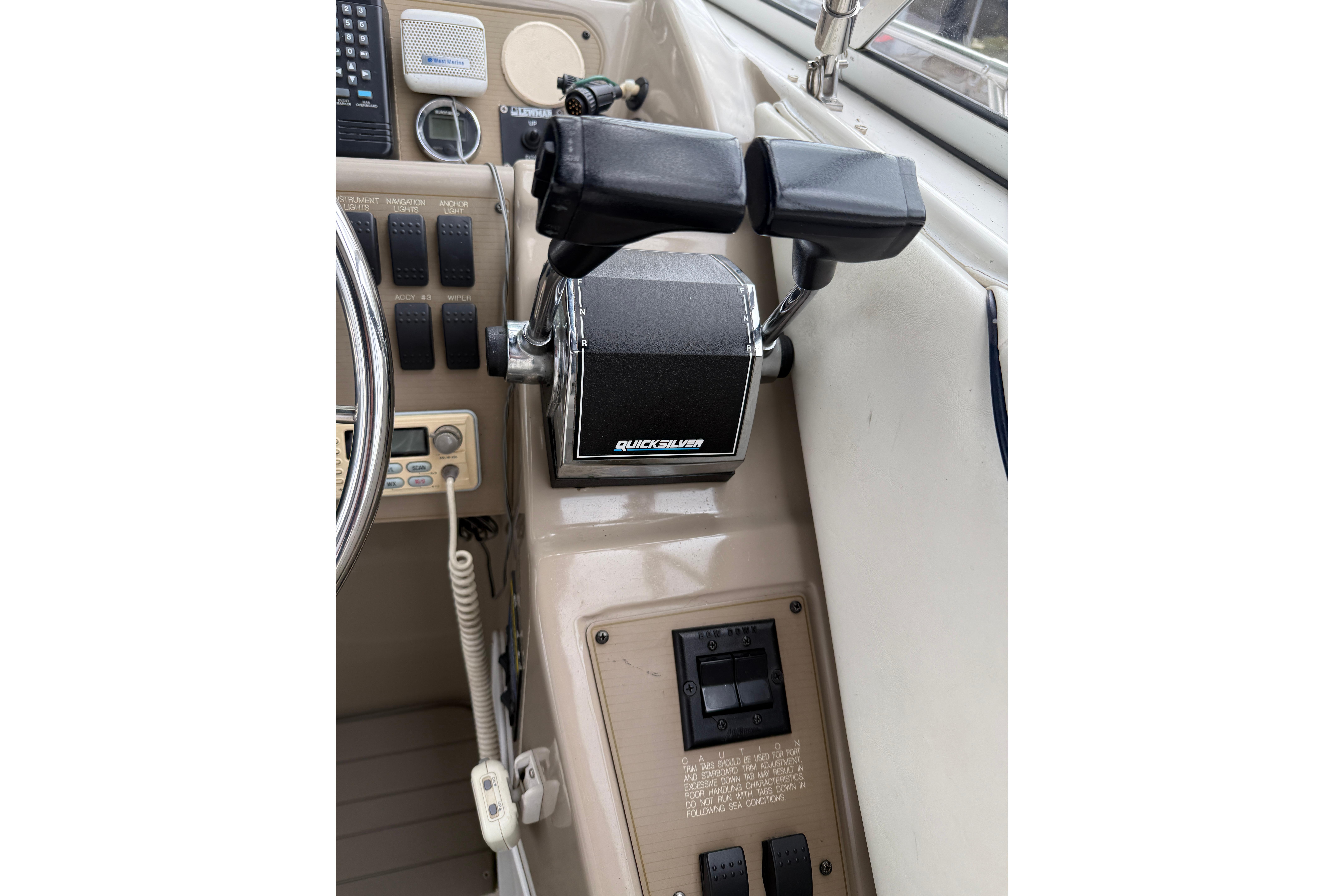 Control panel of a 1997 Bayliner 3255 Avanti boat with Quicksilver throttle.
