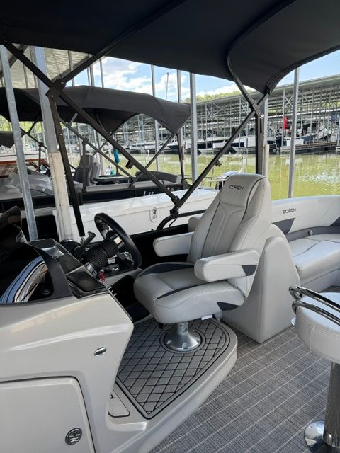 Interior of 2023 Coach Pontoons 263REC with luxurious seating area.