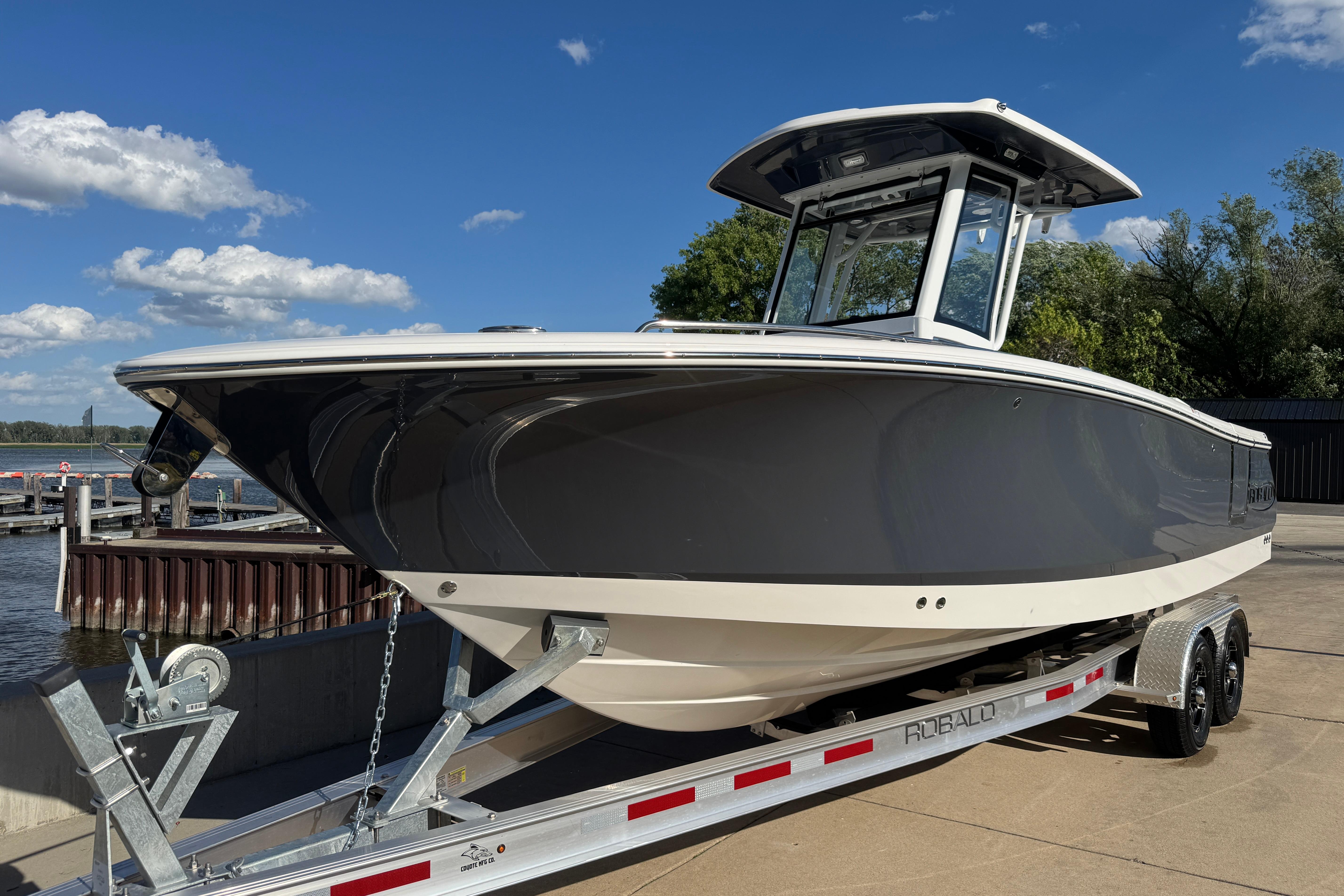 2026 Robalo R250 Center Console boat on trailer by the water.