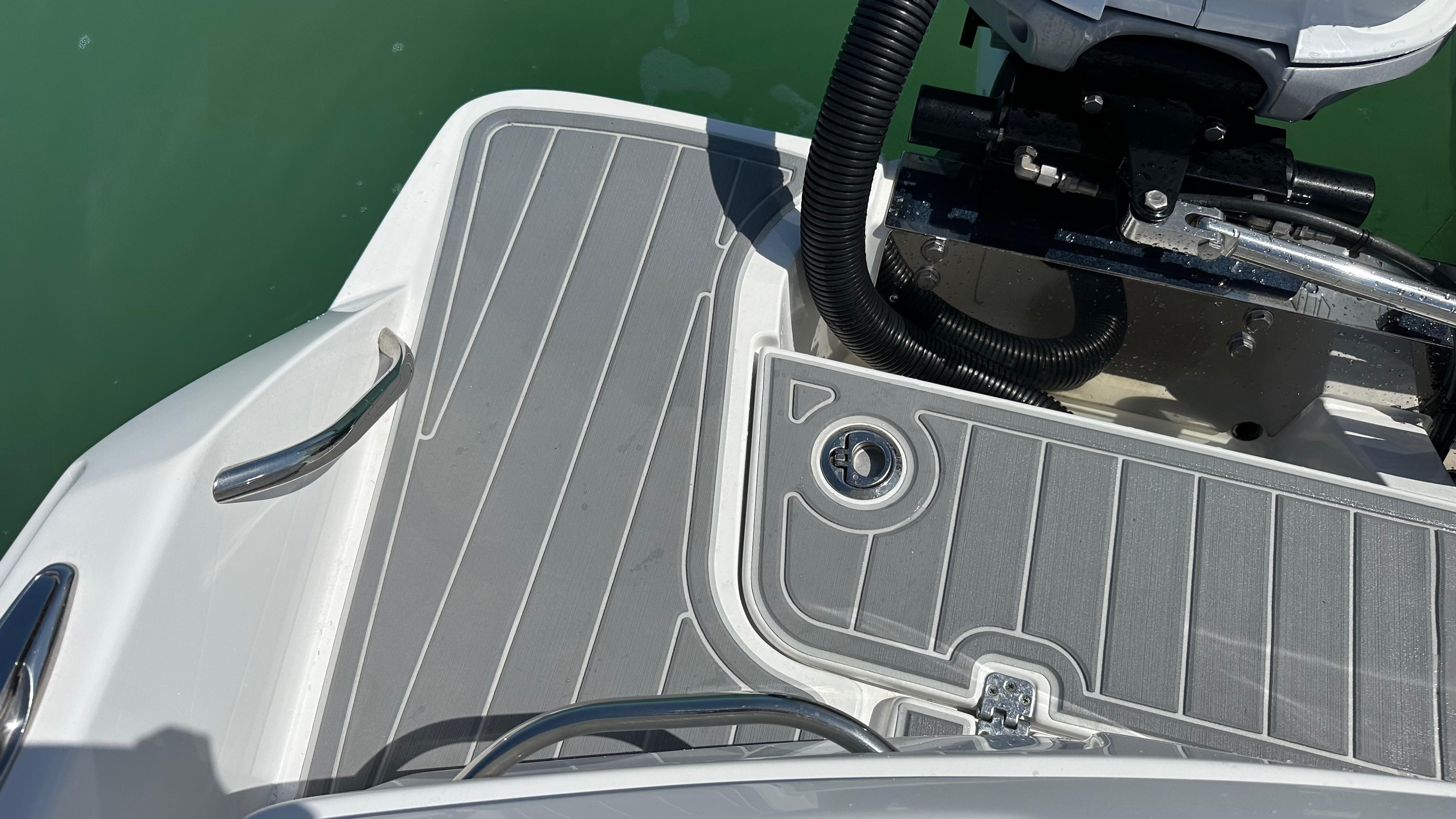 2018 Nor-Tech 340 Sport Center Console boat deck with sleek gray flooring.