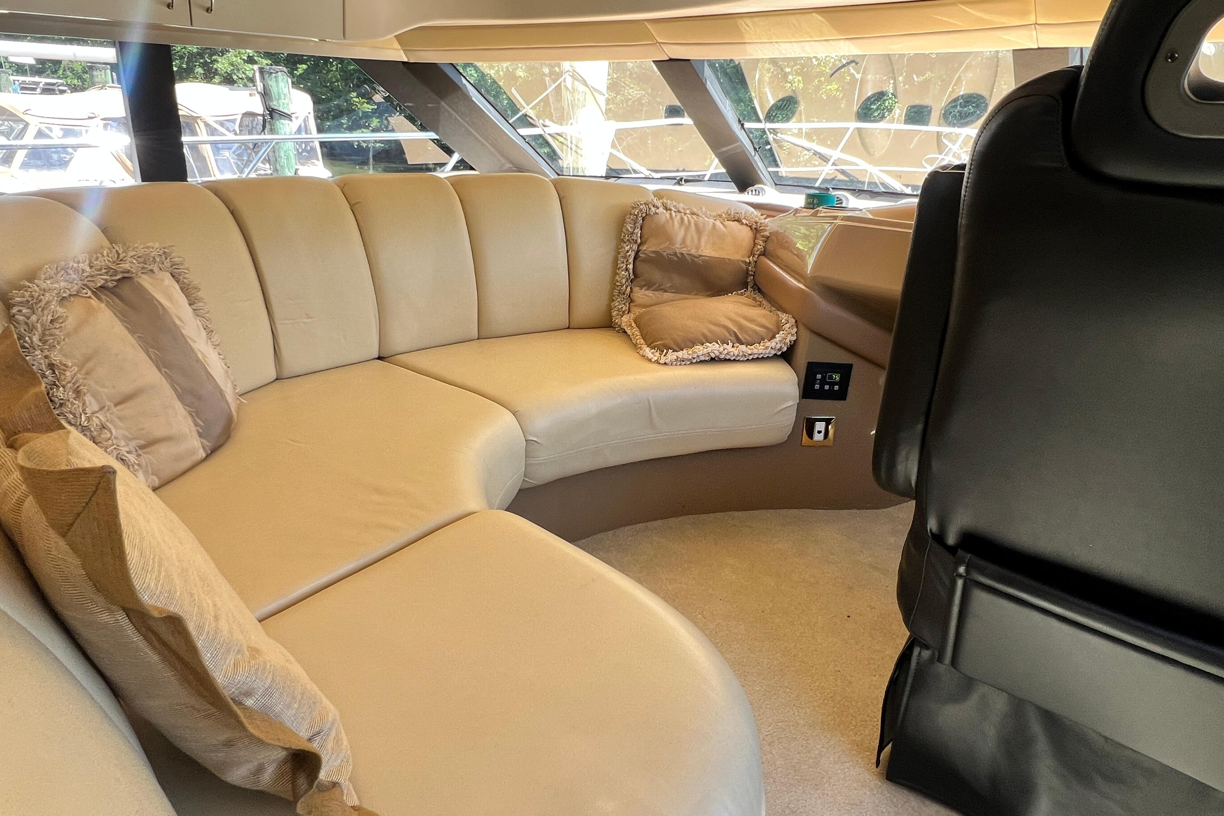 Luxurious interior of 2003 Carver 450 Voyager Pilothouse with plush seating and cushions.