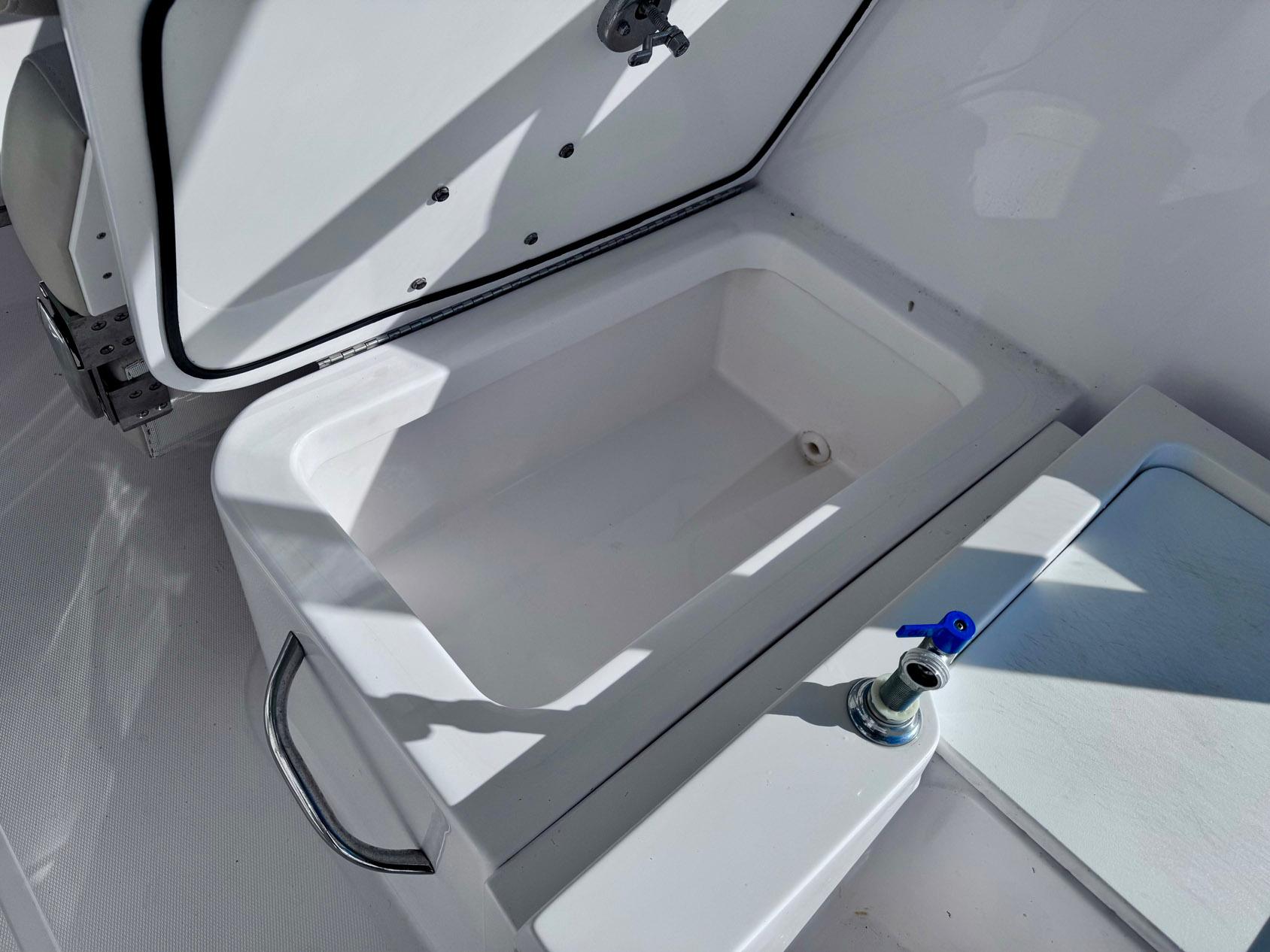 Open storage compartment on 2022 Stamas 370 Aegean boat, featuring a sleek white design.