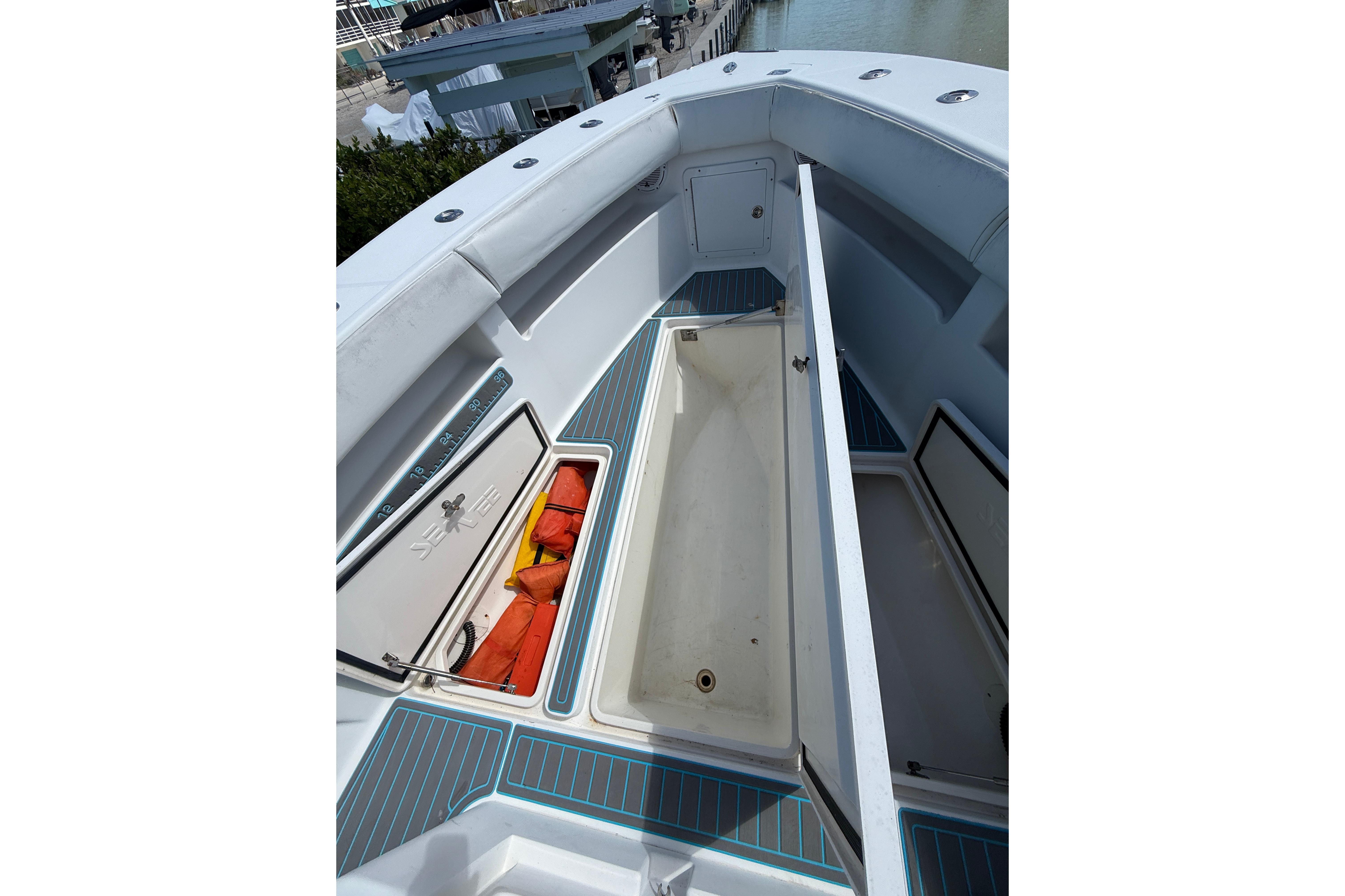 2006 SeaVee 290B boat deck with open storage compartments and safety gear.