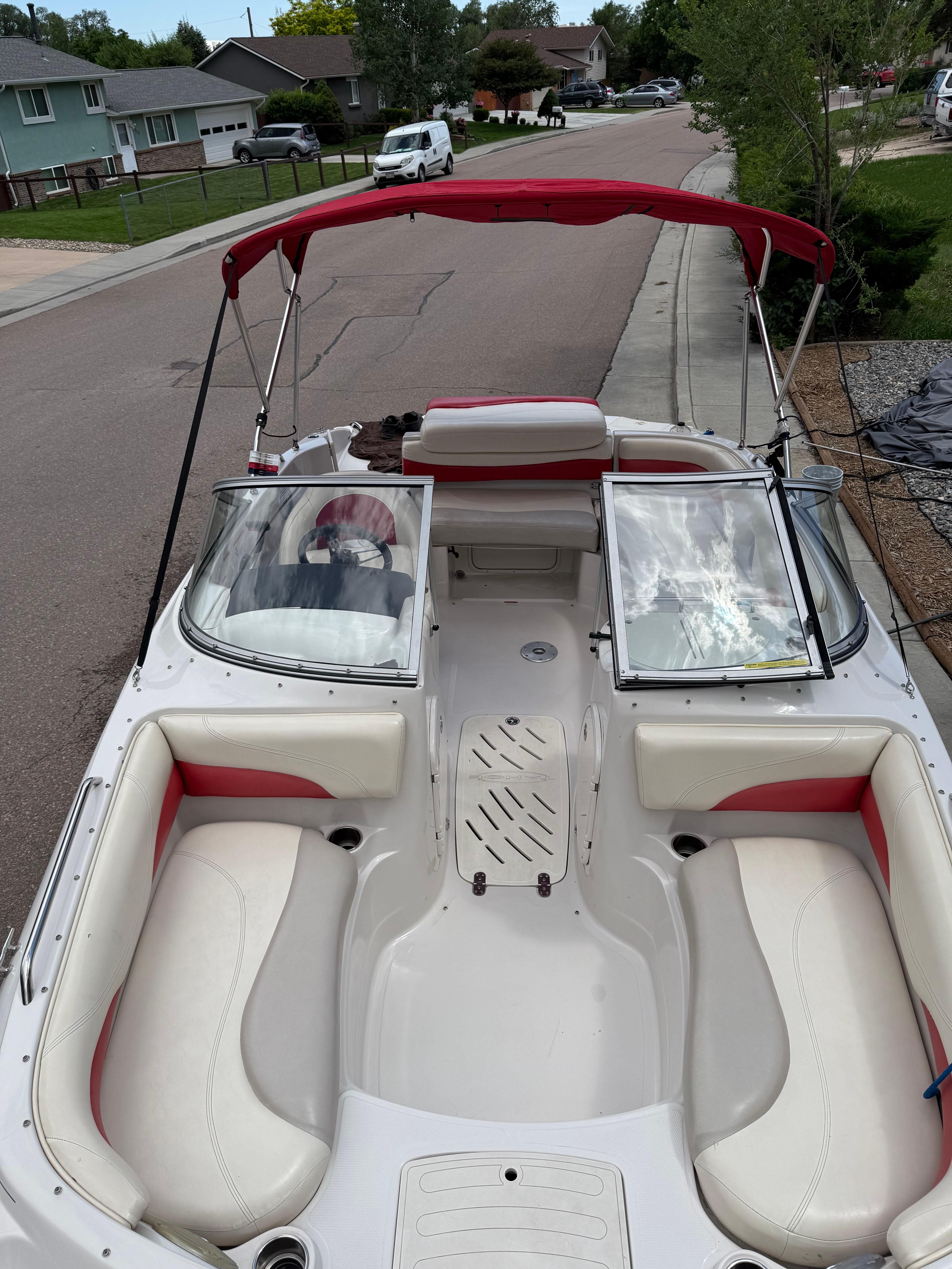 2011 Tahoe 216 WT boat parked on a street.