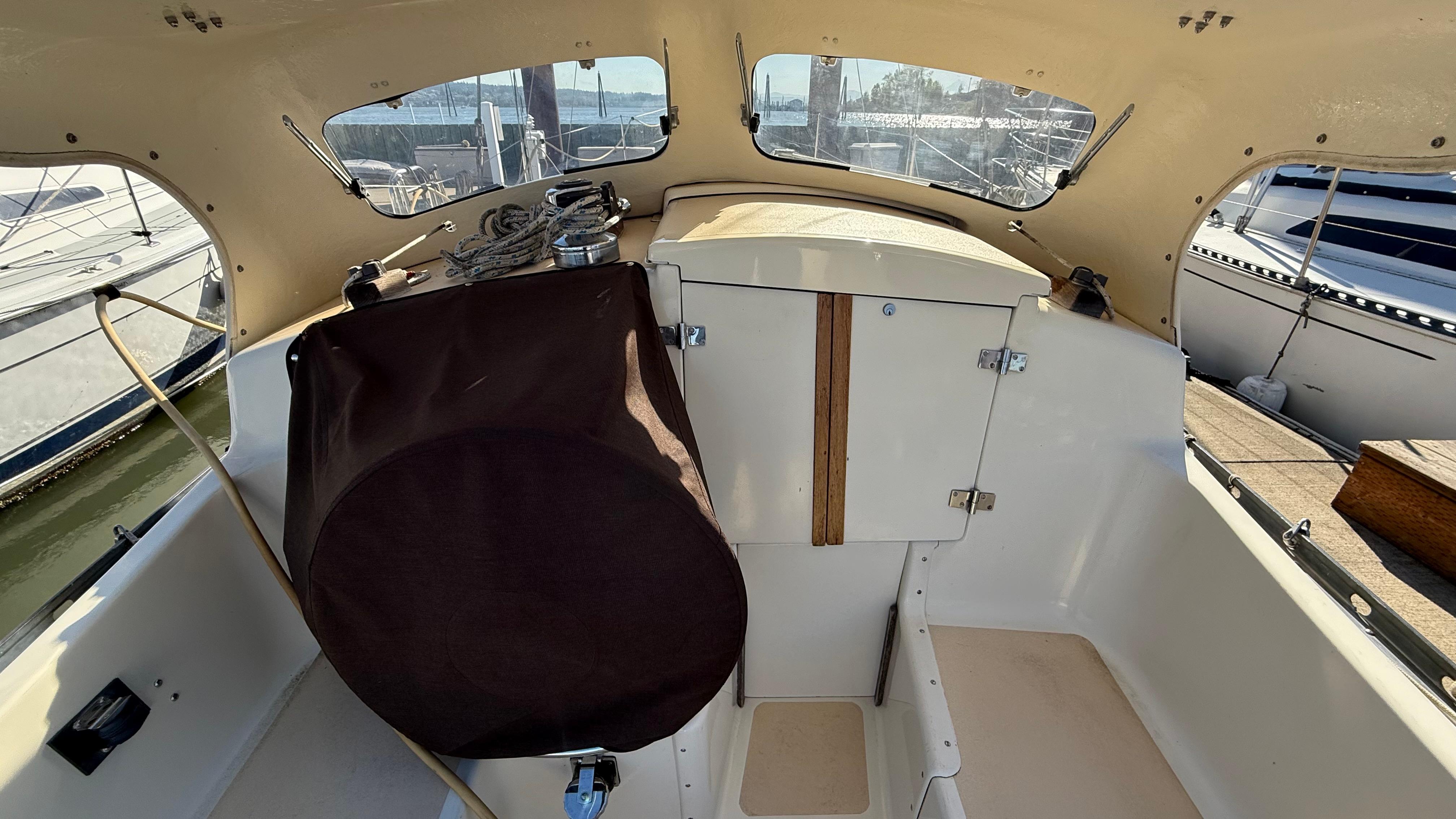 1984 Cascade 36 sailboat cockpit with covered wheel and cabin entrance.