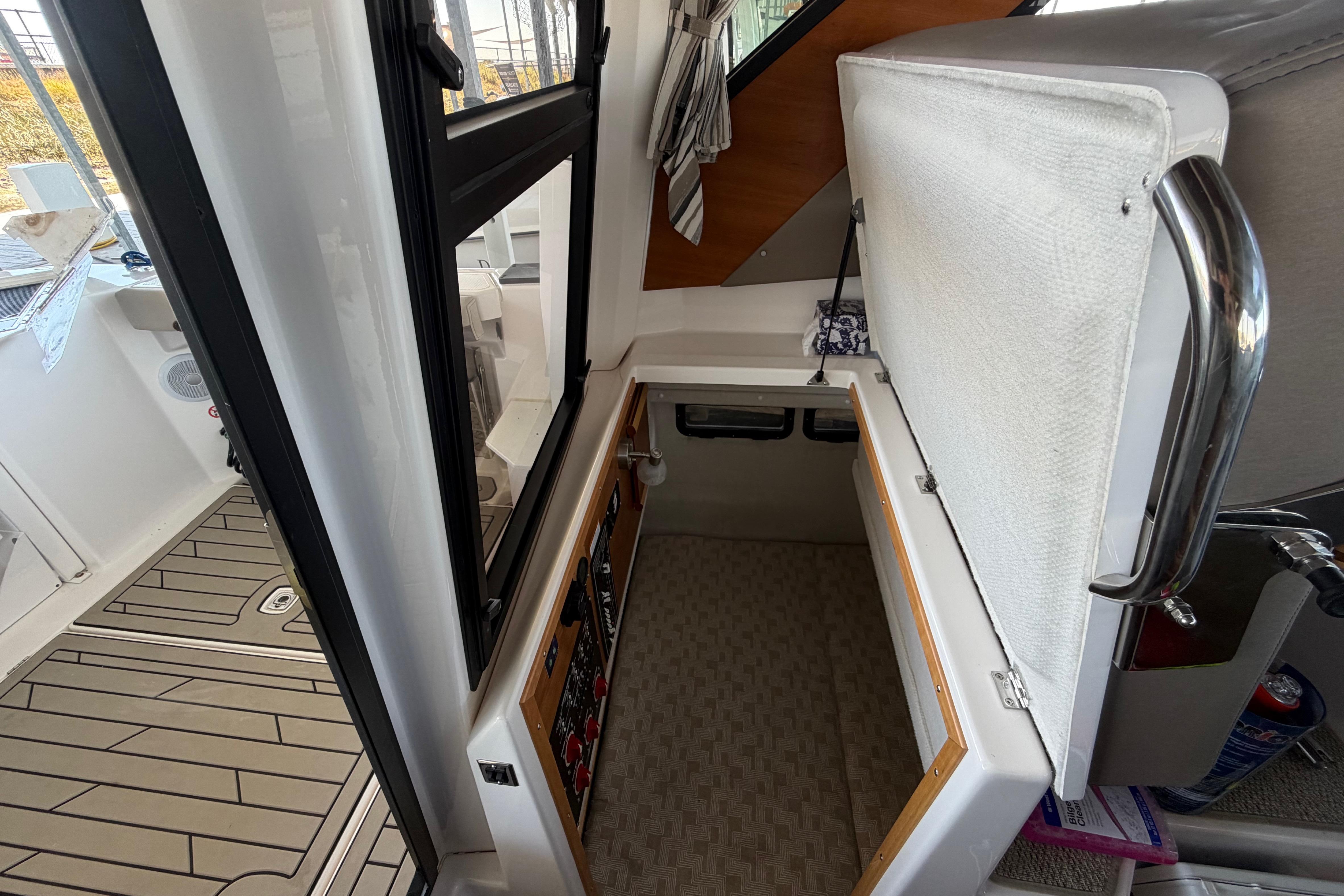 2023 Cutwater C-288 Coupe interior with open storage compartment and modern design.