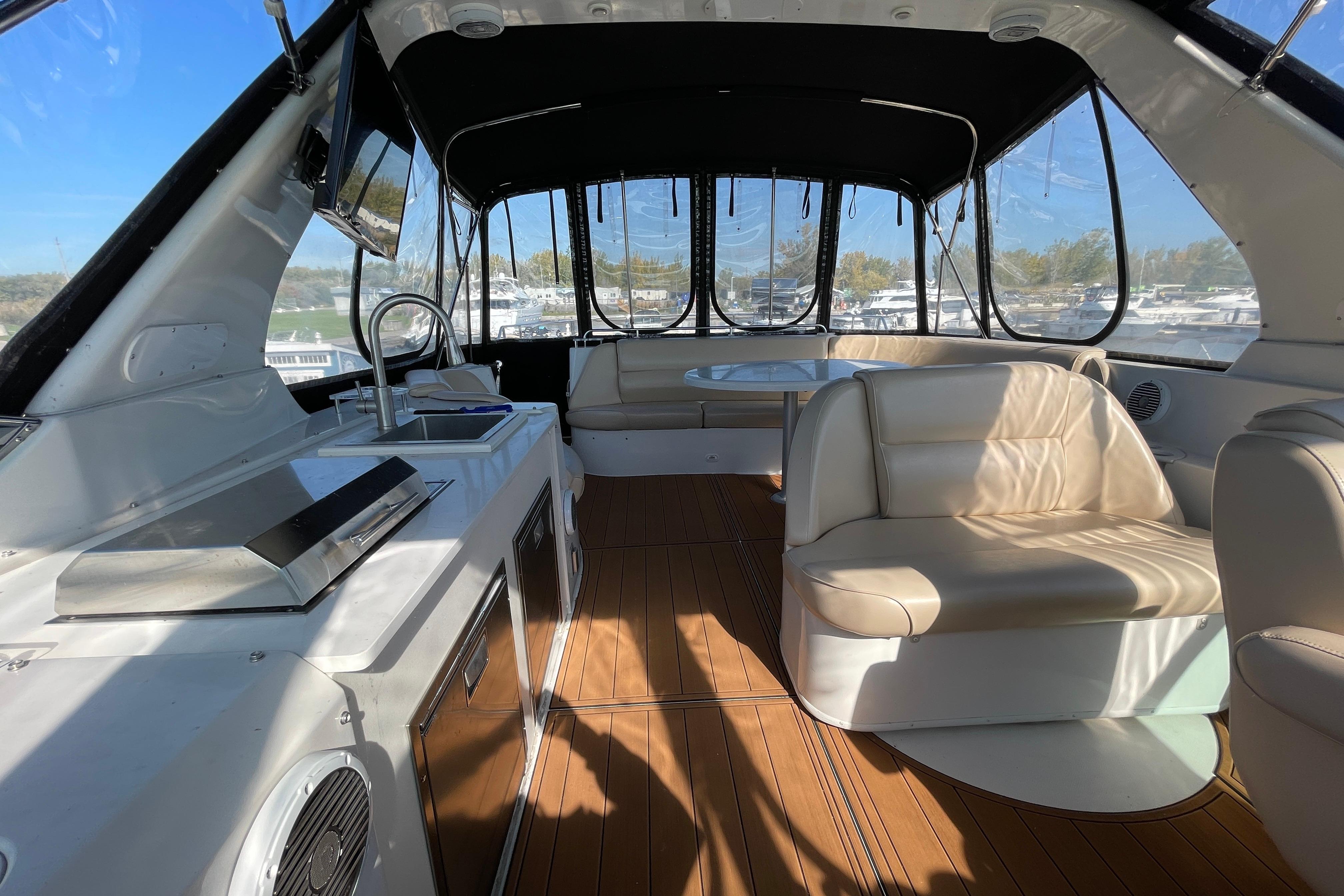 Luxurious interior of 2002 Carver 570 Voyager Pilothouse with seating and kitchenette.